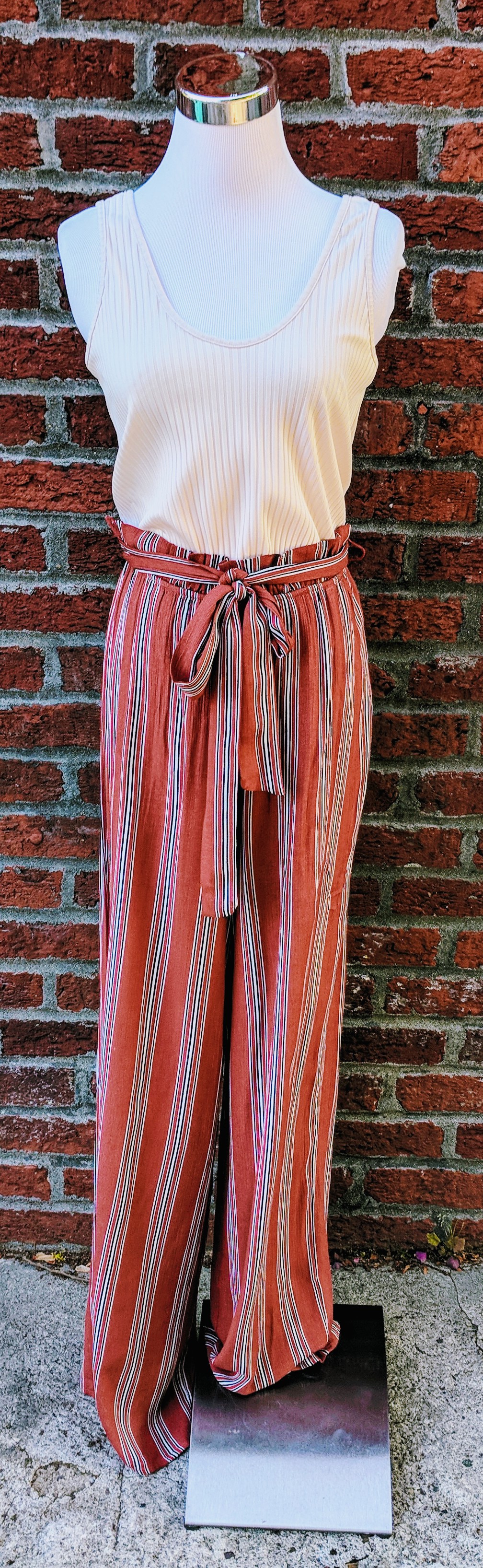 Rust and cream jump with belted waist. 