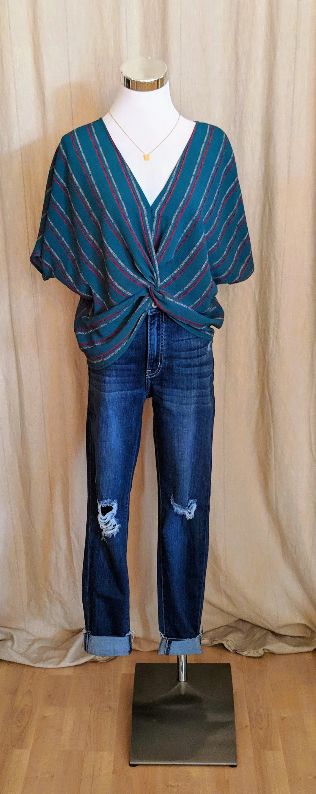 Teal Green stripe twist front top with high low hem. 