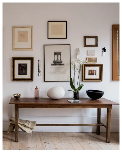 A beautiful arrangement of pictures and objects in the couple's bedroom.