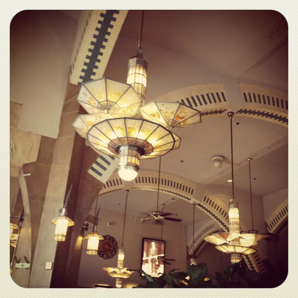 Stunning lights in the historic and cavernous Cafe Americain where we stopped for a coffee.