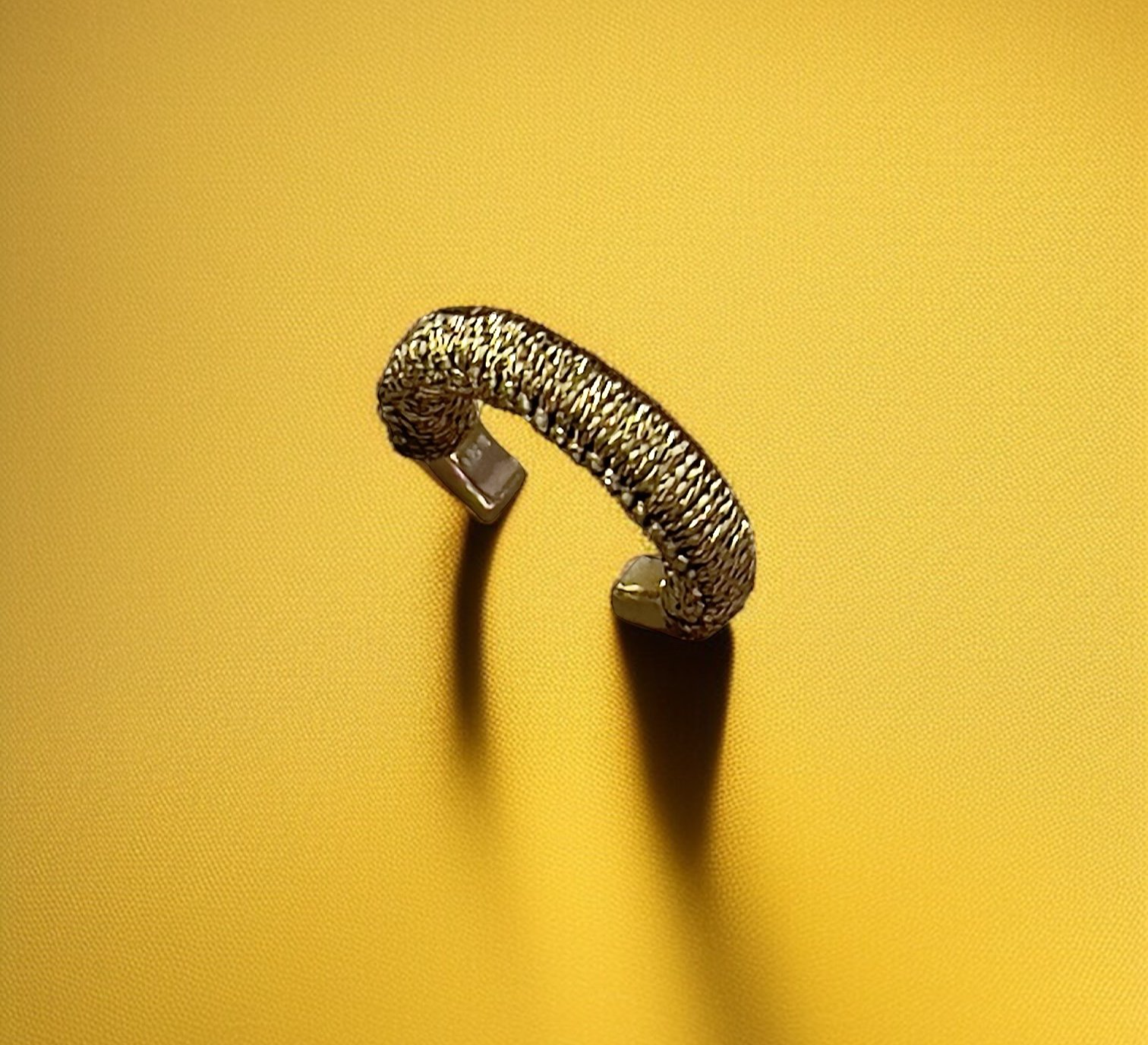 ERCBG107YG+14KT+SOLID+YELLOW+GOLD+14MM+BY+3MM+EAR+CUFF+HAND+WOVEN+WITH+GOLD+CORD+AD+1.png