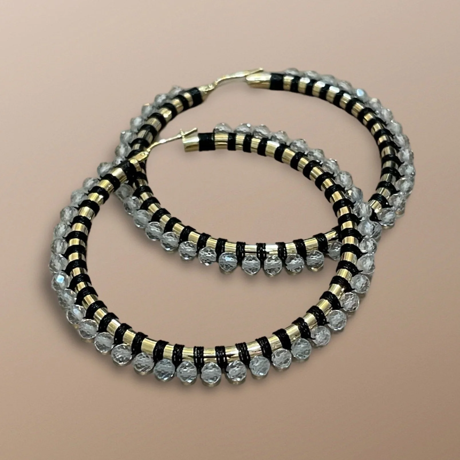 ELR100+14KT+YELLOW+GOLD+HOOPS+HANDWOVEN+WITH+WHITE+TOPAZ+AND+BLACK+CORD.jpg