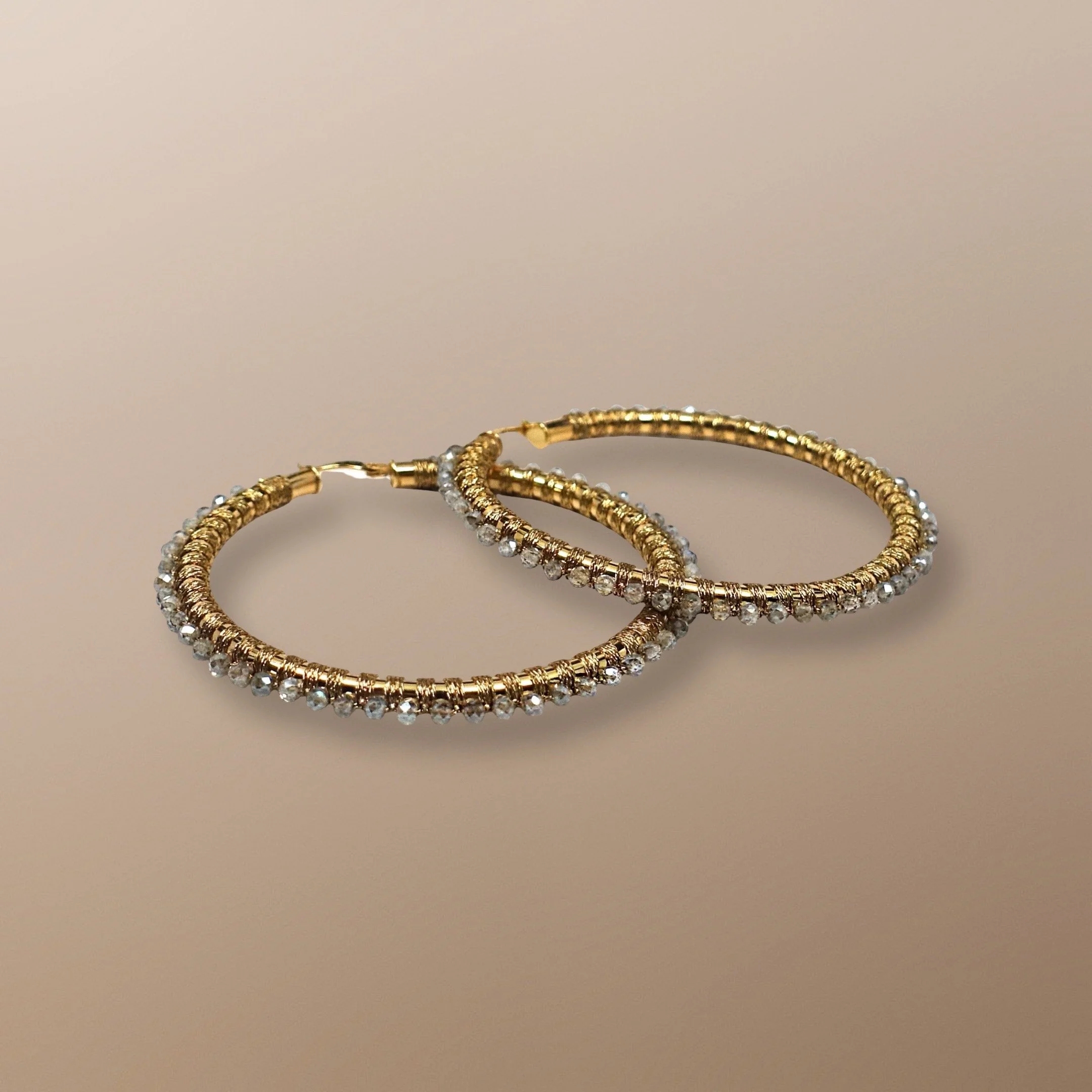 AQE111YG 14KT GOLD HOOP HAND WOVEN WITH MYSTIC LABRADORITE. ALSO AVAILABLE IN ROSE GOLD, AND FIVE SIZES. LABRADORITE REPRESENTS THE "TEMPLE OF THE STARS"