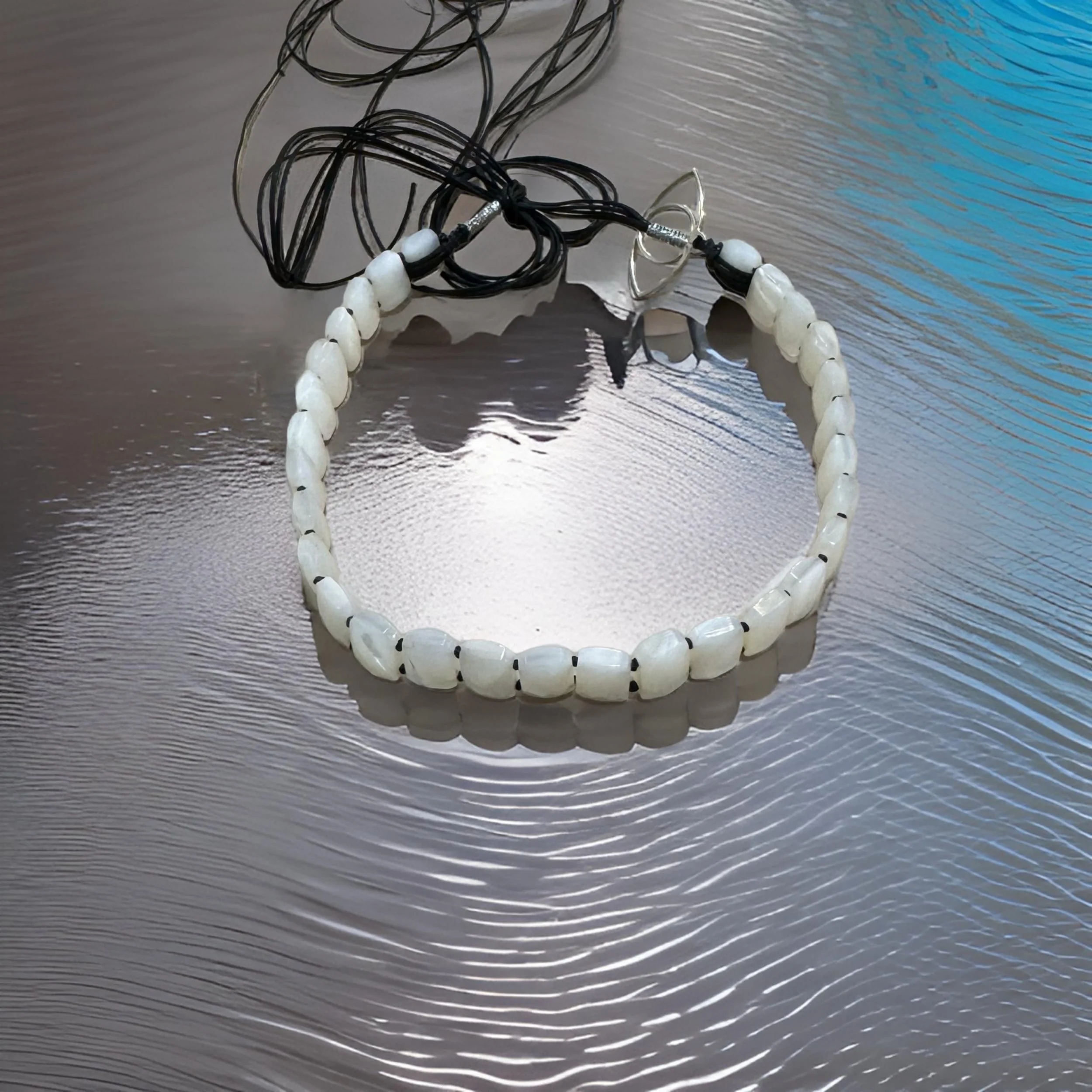 NANDA116 12MM X 8MM FACETED WHITE SOUTH SEA MOTER OF PEARL CHOKER WITH STERLING SILVER 30MM EYE CHARM AD 3.JPG