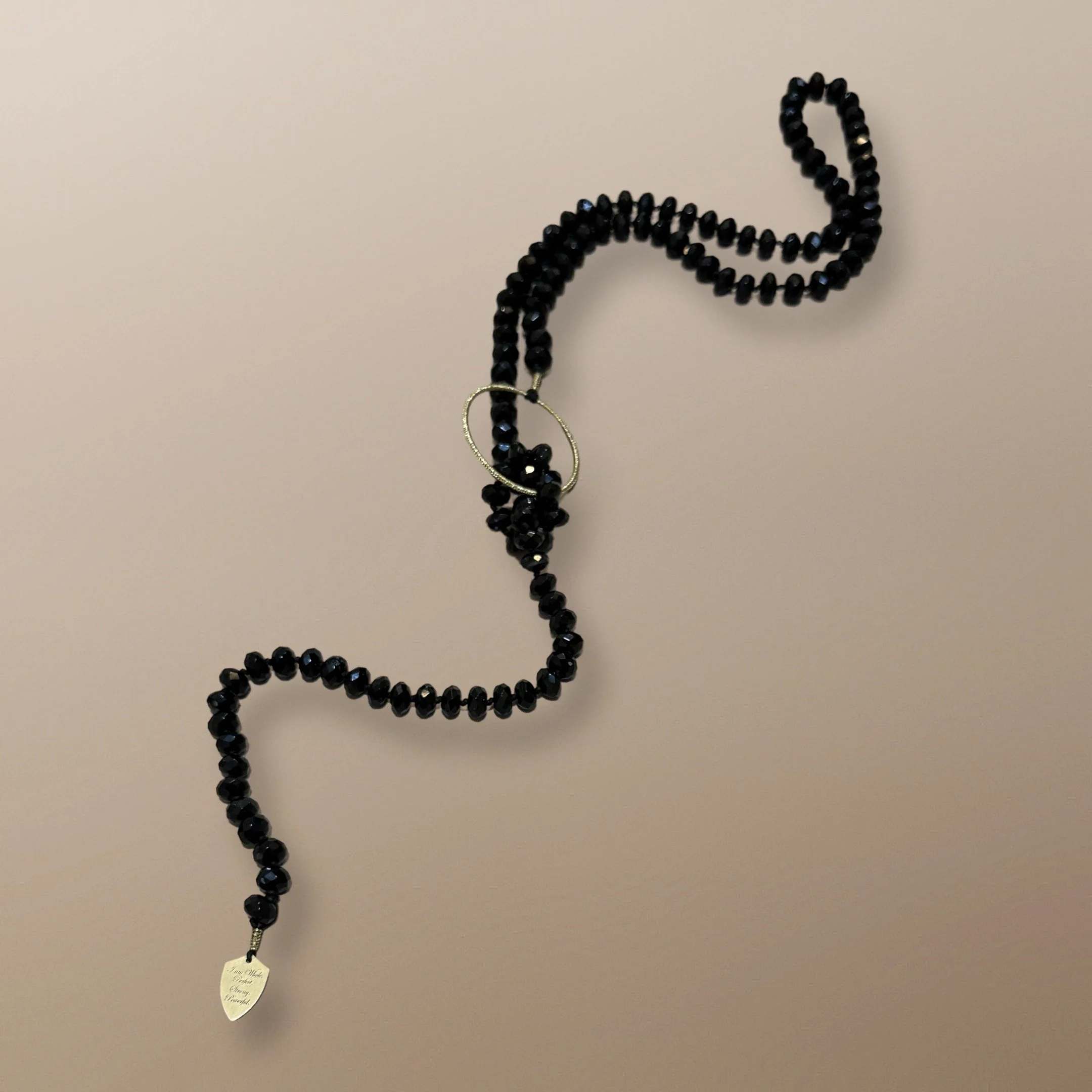 NANDA105	10MM X 6MM FACTED RONDEL BLACK AGATE BEADS LARIAT WITH 44MM HANDWOVEN CIRCLE AND LASER ENGRAVED SHIELD 40”