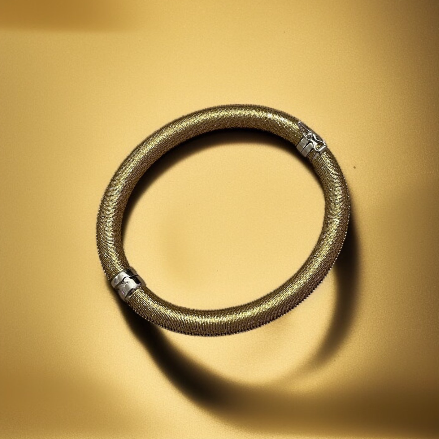 BRBG101+GLD+STERLING+SILVER+6MM+HINGED+BANGLE+HAND+WOVEN+WITH+GOLD+CORD+AD.png