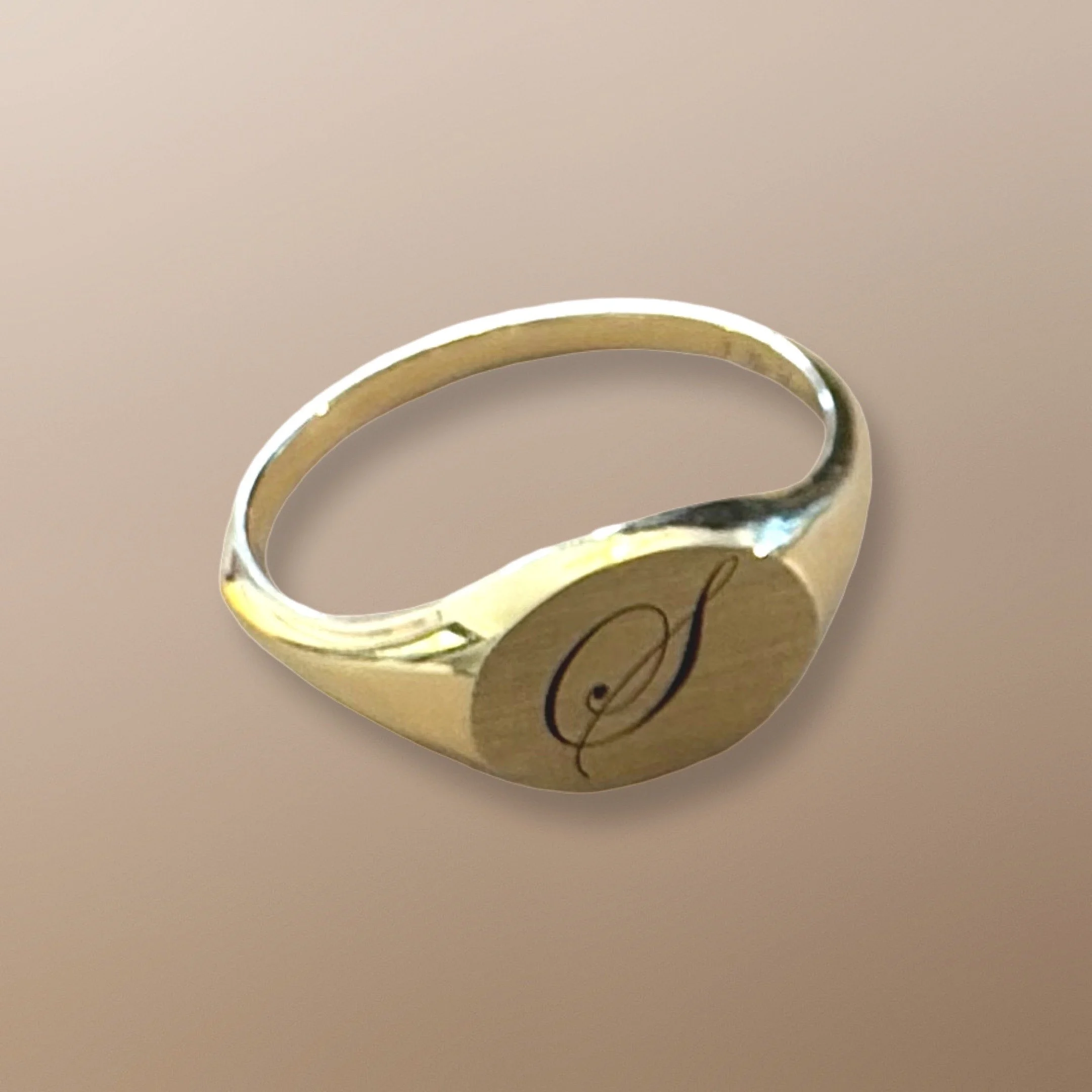 Insignia A 14k yellow gold signet ring engraved with the letter S for Sacred. You may choose your own initial. The inside of the ring is engraved with  I AM LOVE.