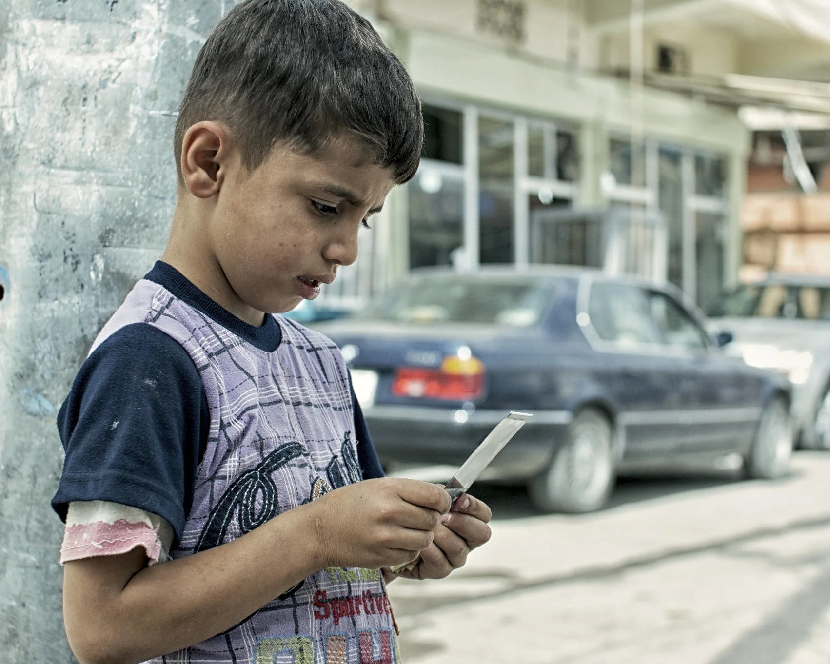 kid in kurdistan watching his polaroid develop / enfant en kurdistan qui regarde polaroid développer