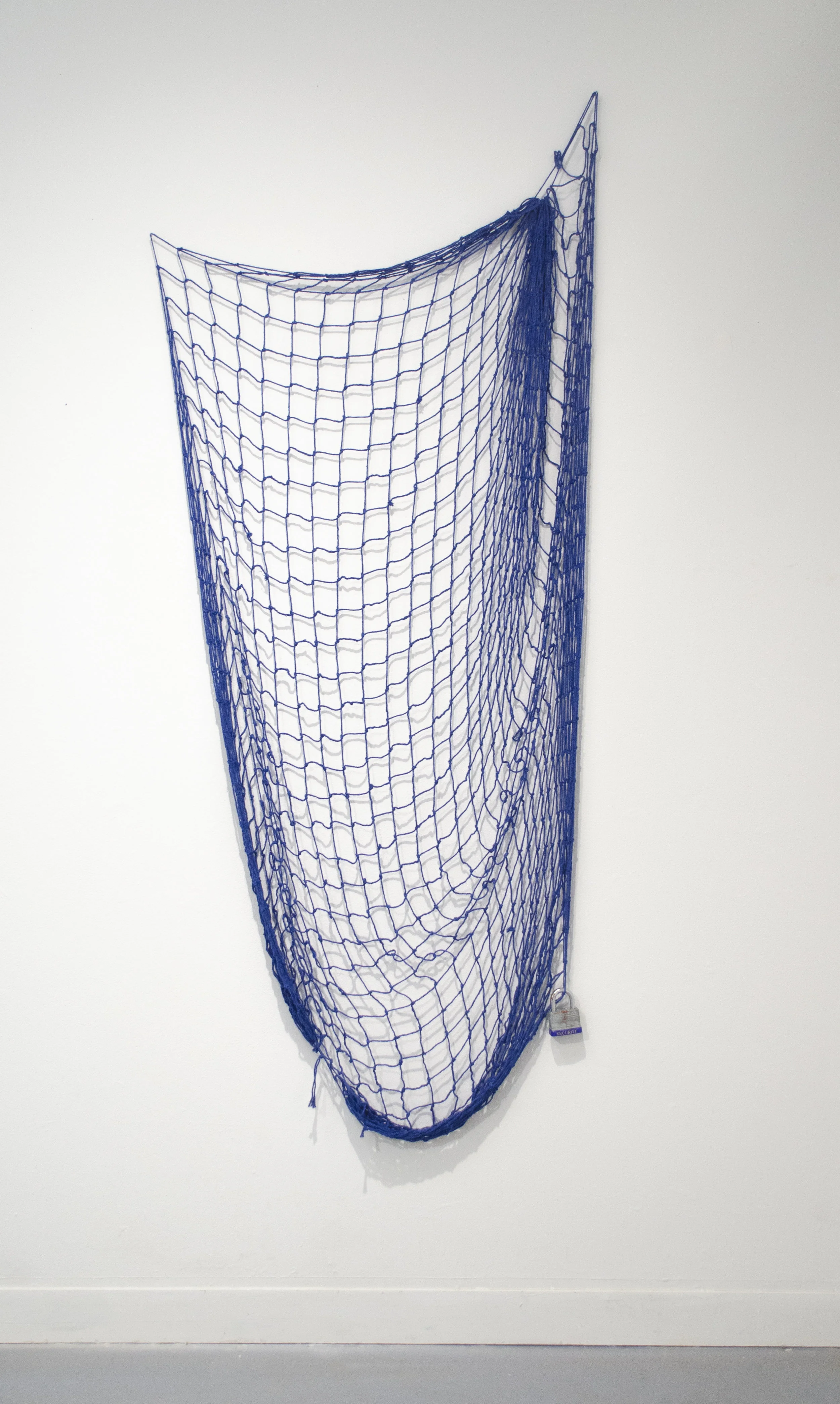 Dragnet fishing net, security lock, 1a : a net drawn along the bottom of a body of water. b : a net used on the ground (as to capture small game) 2 : a network of measures for apprehension (as of criminals) 60”x 30”x 2” 2019