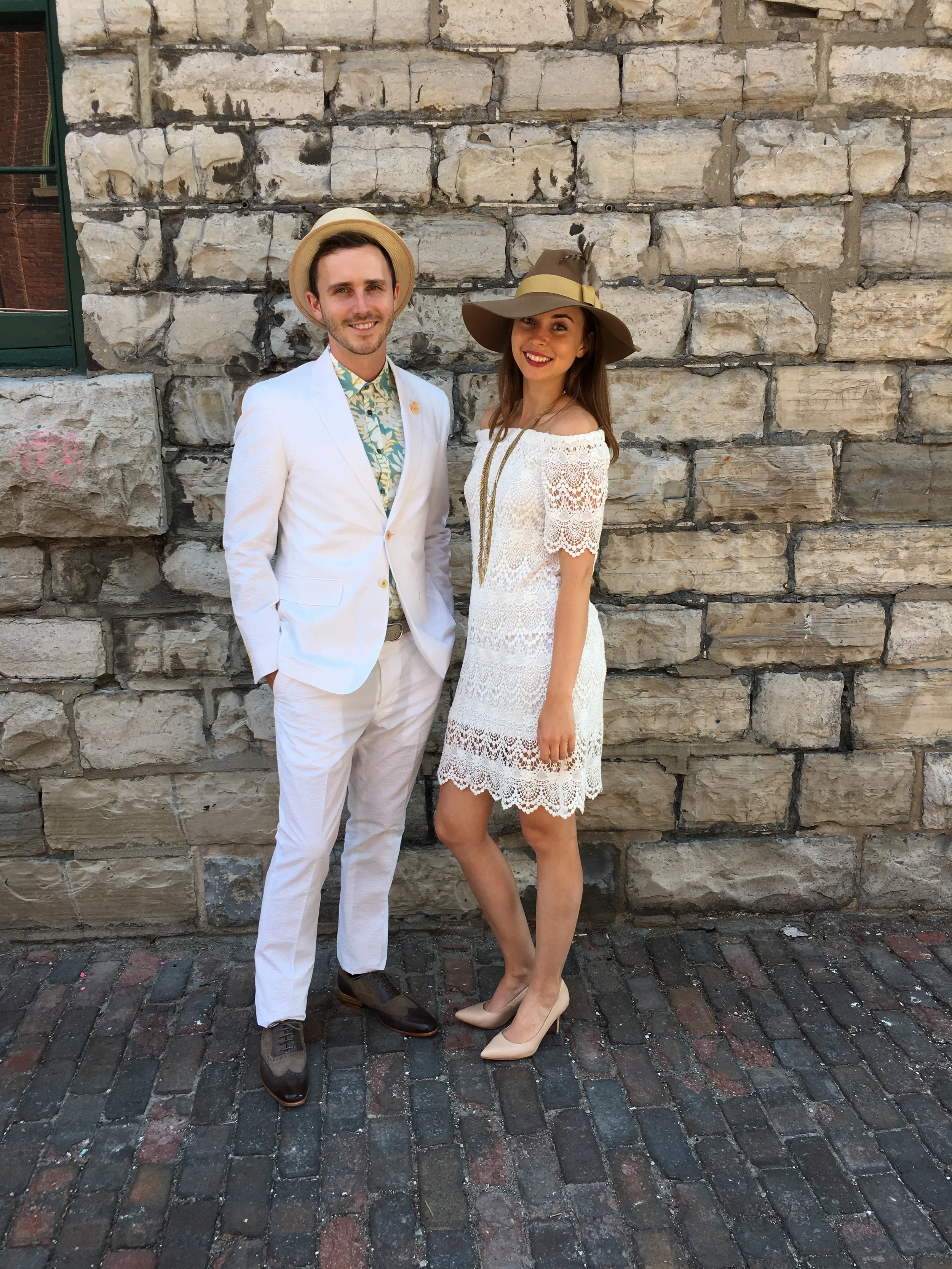 Outfit Details: Conor is wearing a hat by David Dunkley, Haspel Gravier seersucker blazer $650 and pants $195, Ted Baker print shirt $169, Paradigma fancy brogues $375, Anderson’s stretch woven belt $160 and Doro lapel pin $19 Sophie is wearing a Velvet off the shoulder lace dress $218 and Tiger of Sweden heels $249, Brixton Hat $80, Jenny Bird Palm Merris Rope $175