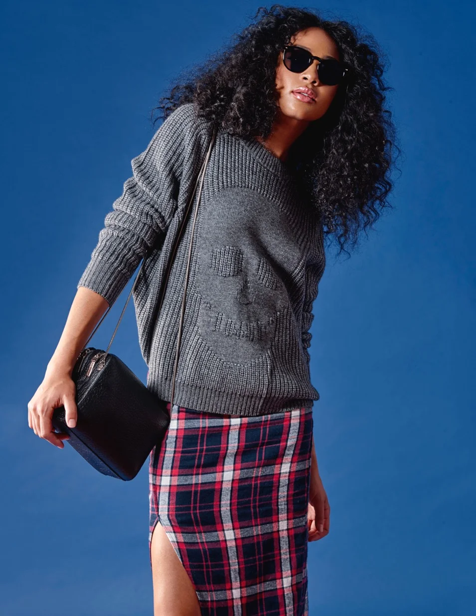 Pair chunky knits with sleek skirts for the perfect Fall look. This edgy combination has street style star written all over it Autumn Cashmere Skull Sweater $395 Nana Judy Plaid Skirt $95 Naked Vice Leather Bag $250