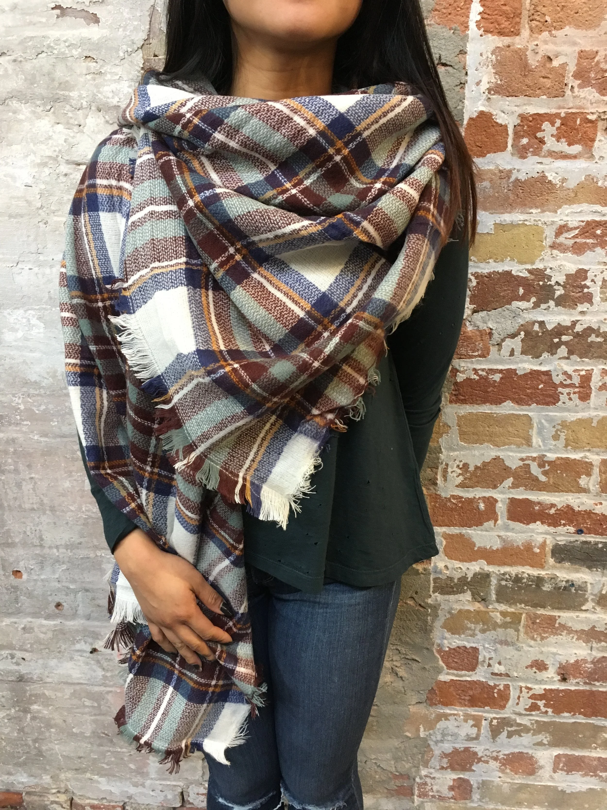 With a larger blanket scarf you have the option of wearing it as a cape! Fold the scarf into a large triangle and simply drape over you as desired, tucking in one corner at the neck to leave one flowing by your side.