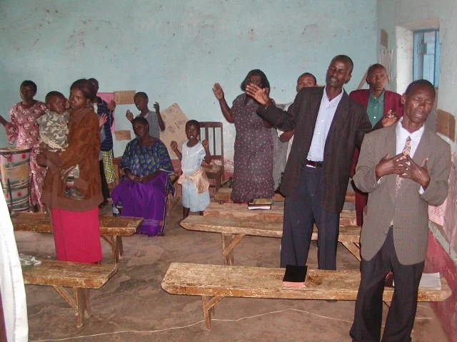 MEMBERS IN THE CHURCH WORSHIPING.JPG