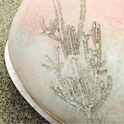 Skipping Stones by artist Jade Oakley. Close up of carved concrete pebbles.