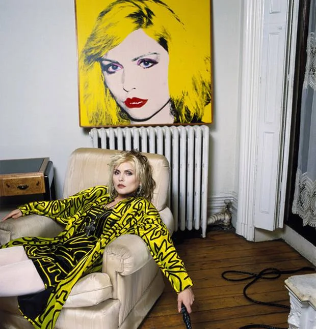 Debbie in her NY apartment in front of a Warhol portrait.