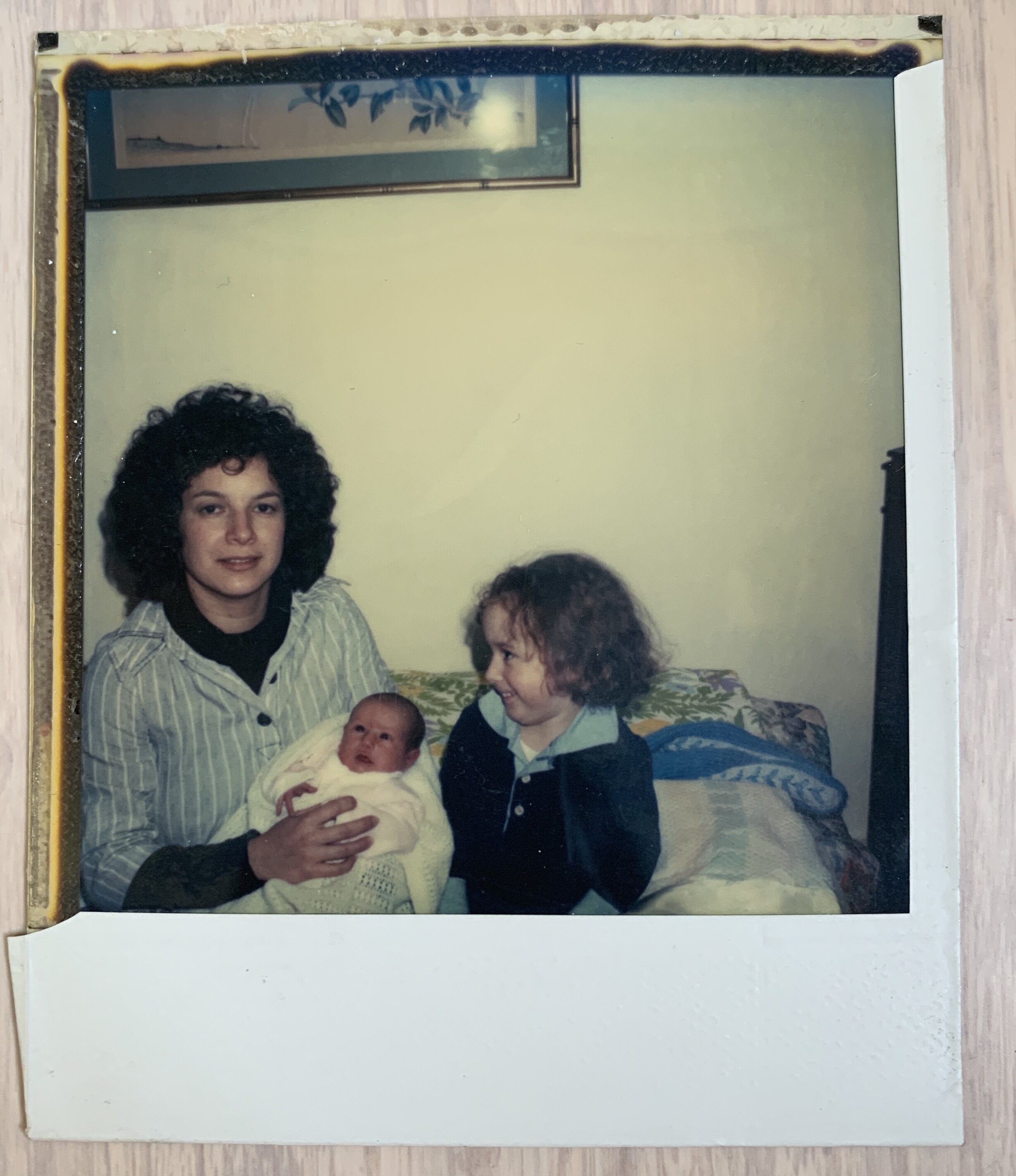 Our mom holding us and our big sister.