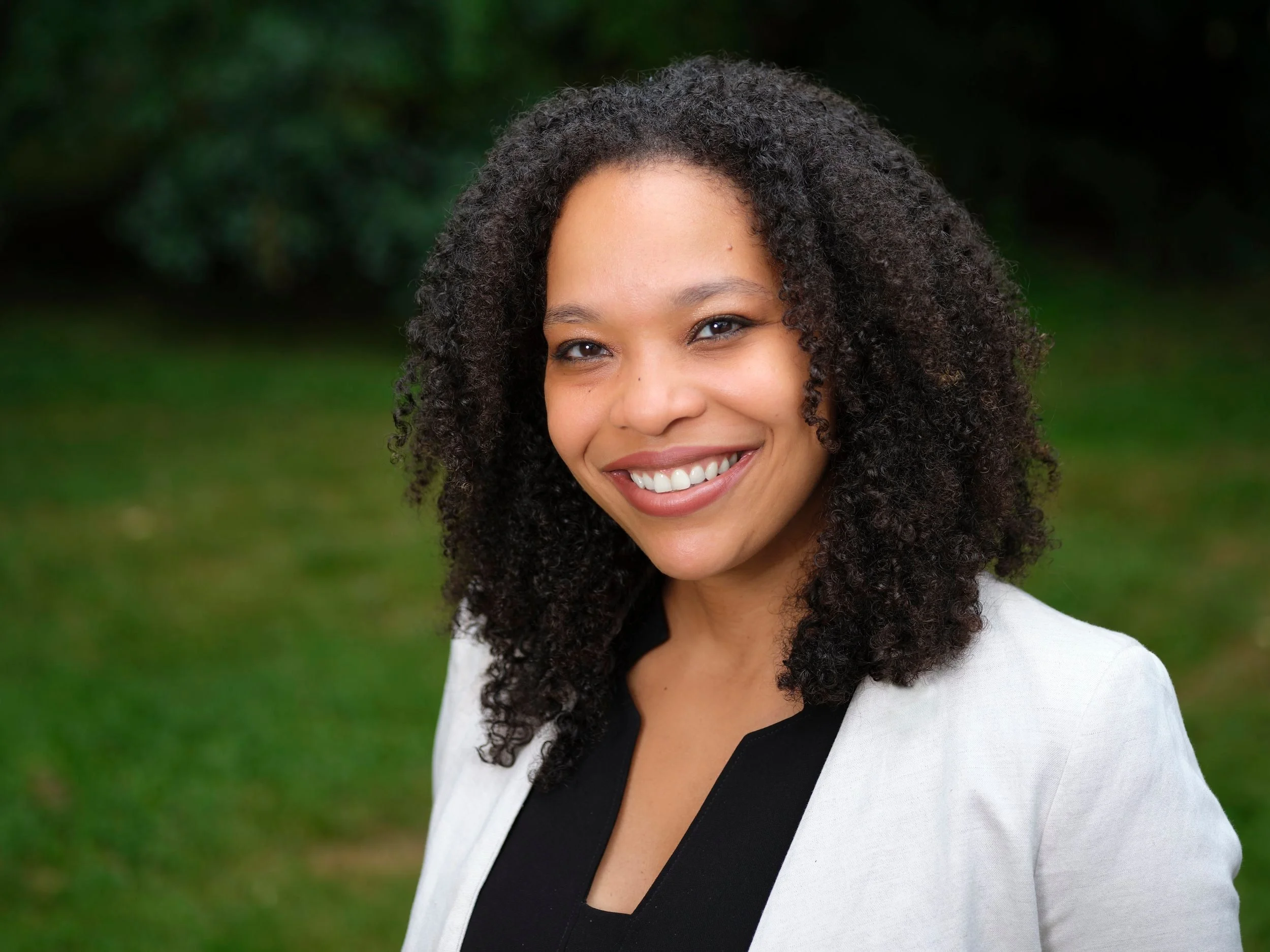 professional-headshot-woman-white-blazer-outdoors.jpg