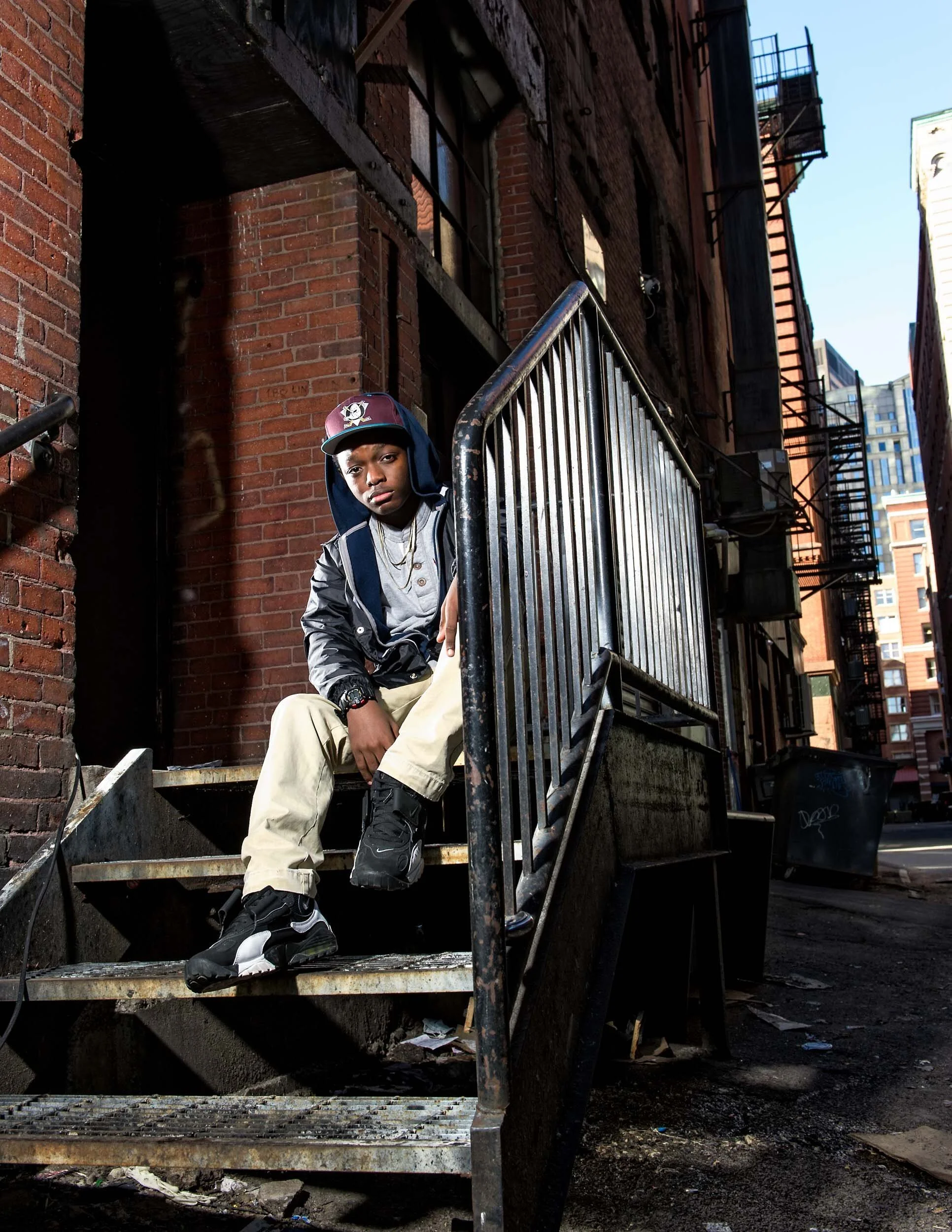 urban-portrait-young-man-brick-alley-stairs.jpg