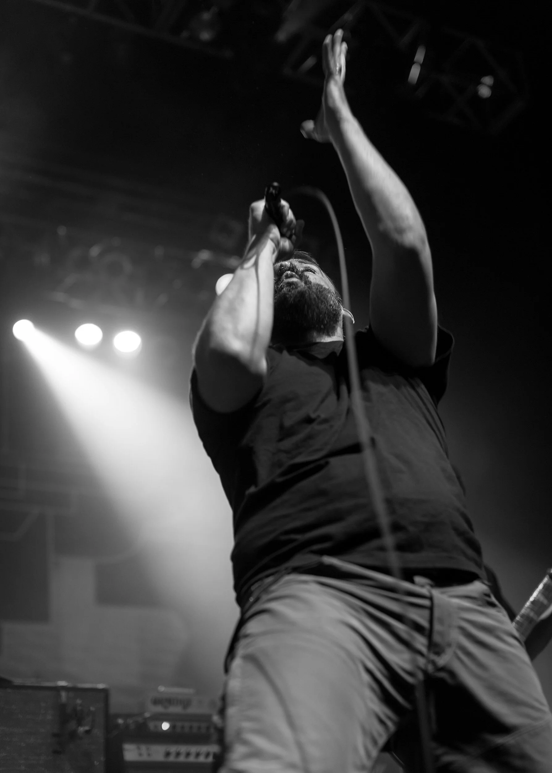 concert-photography-singer-arm-raised-stage-lights.jpg