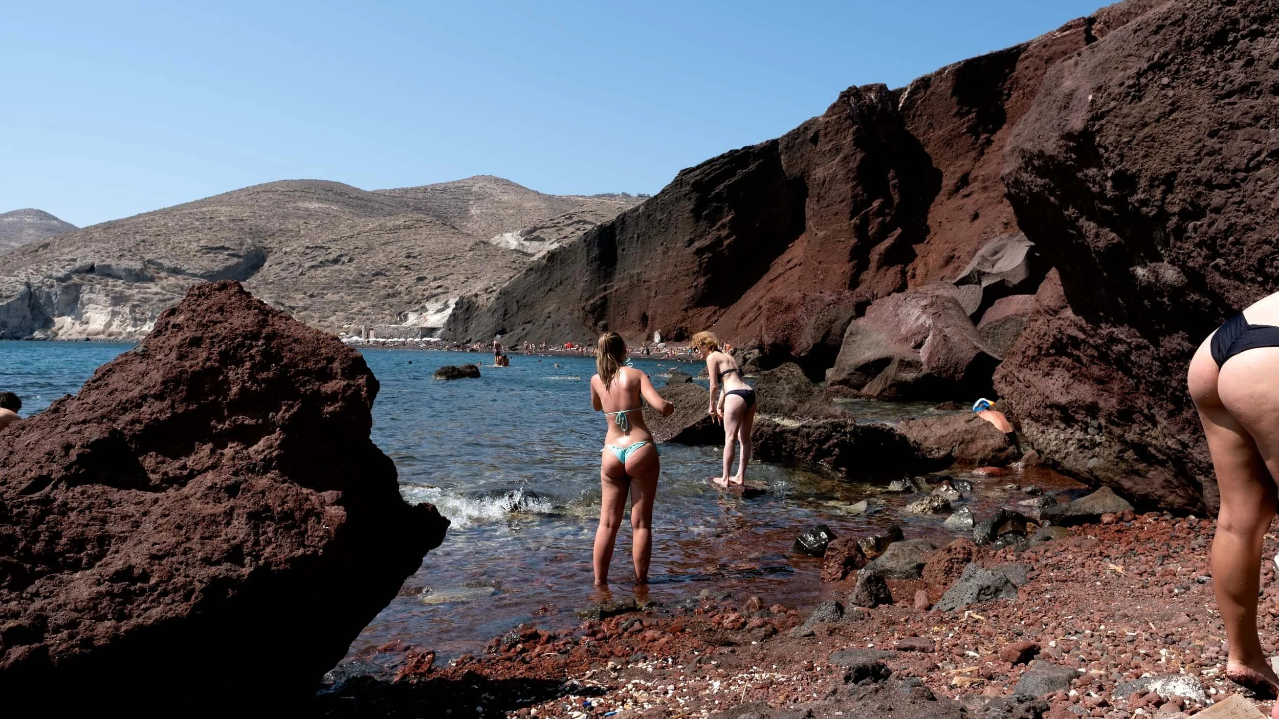 santorini-greece-swimmers-red-volcanic-rock-beach.jpg