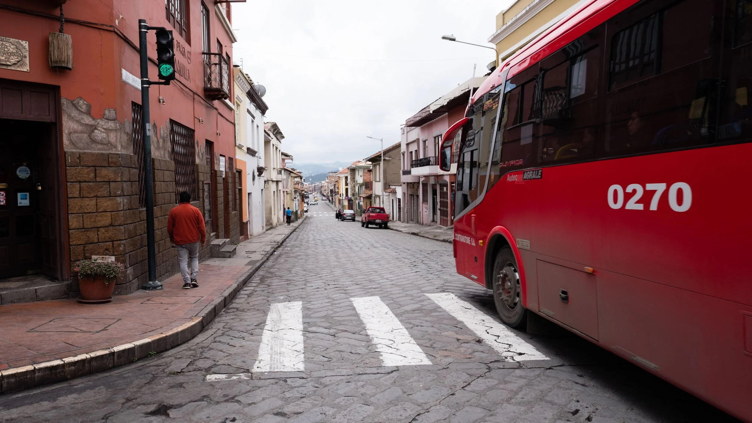 ecuador-red-city-bus-narrow-colonial-street.jpg