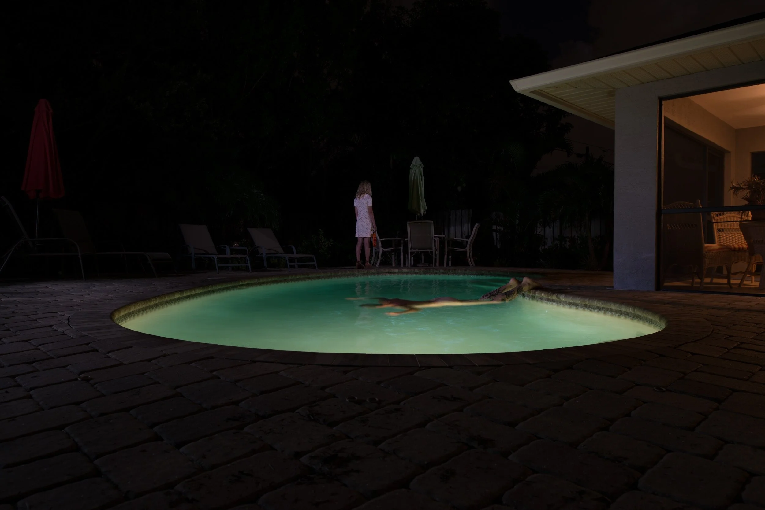 crumpled-fine-art-man-floating-backyard-pool-night.jpg