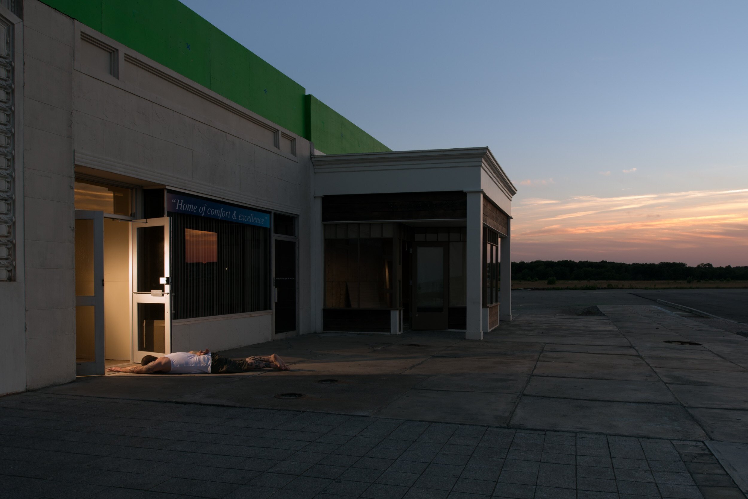 crumpled-fine-art-man-collapsed-doorway-dusk.jpg