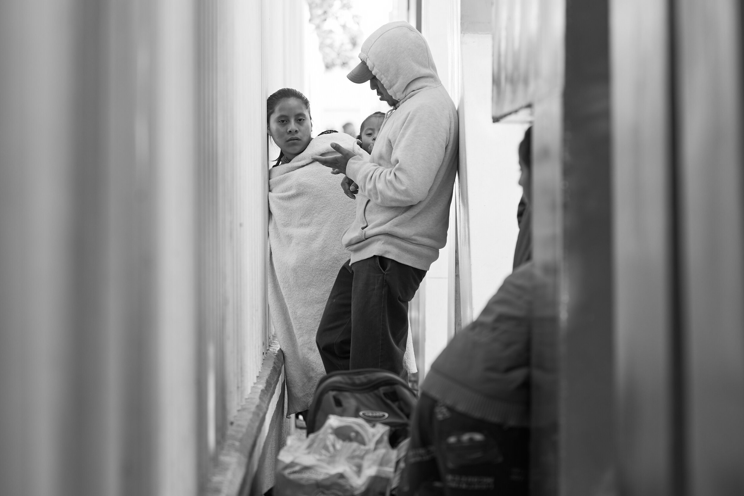 migrants-with-small-child-narrow-passage.jpg