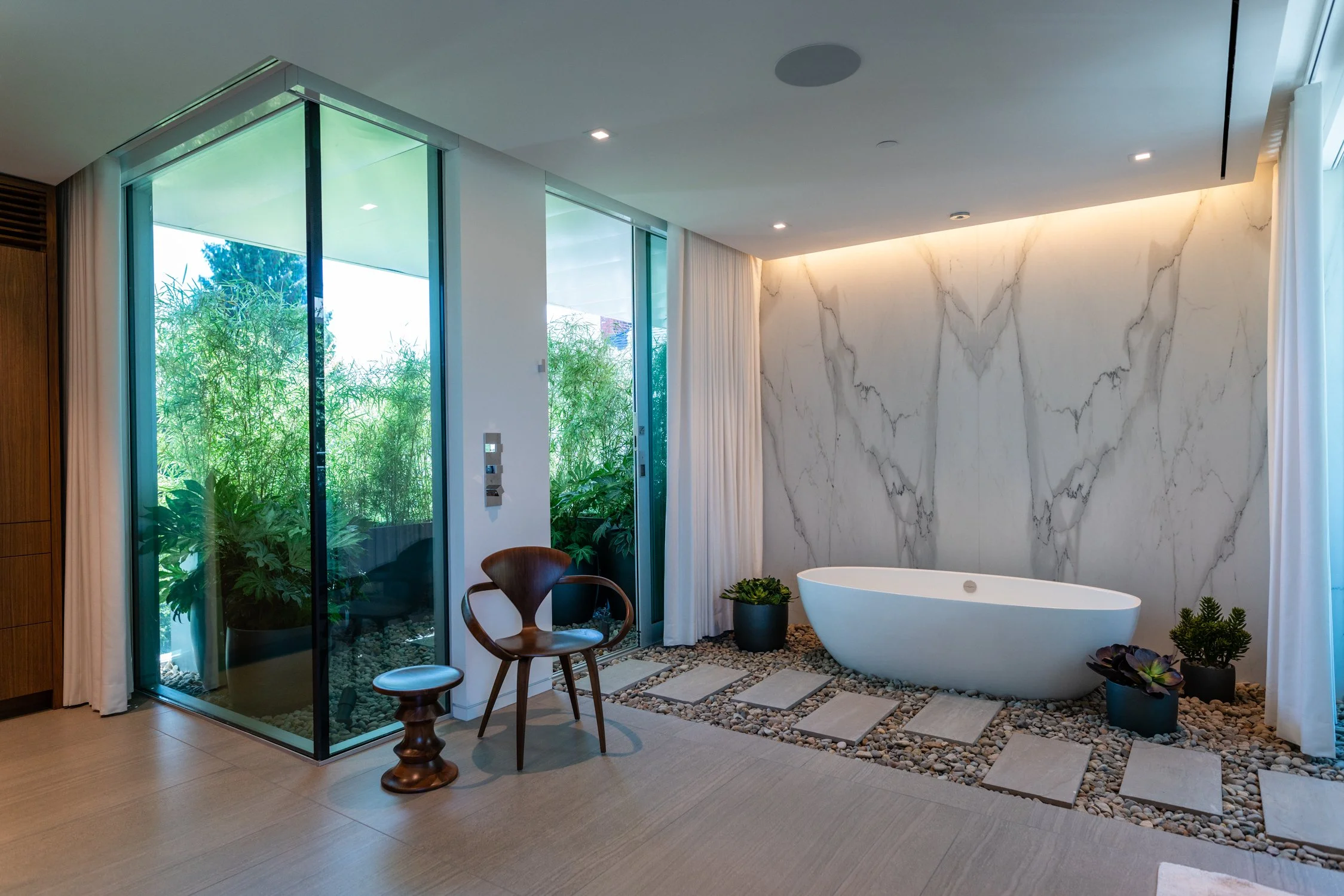 View of outdoor shower from primary spa at Skyview, designed by William / Kaven Architecture.