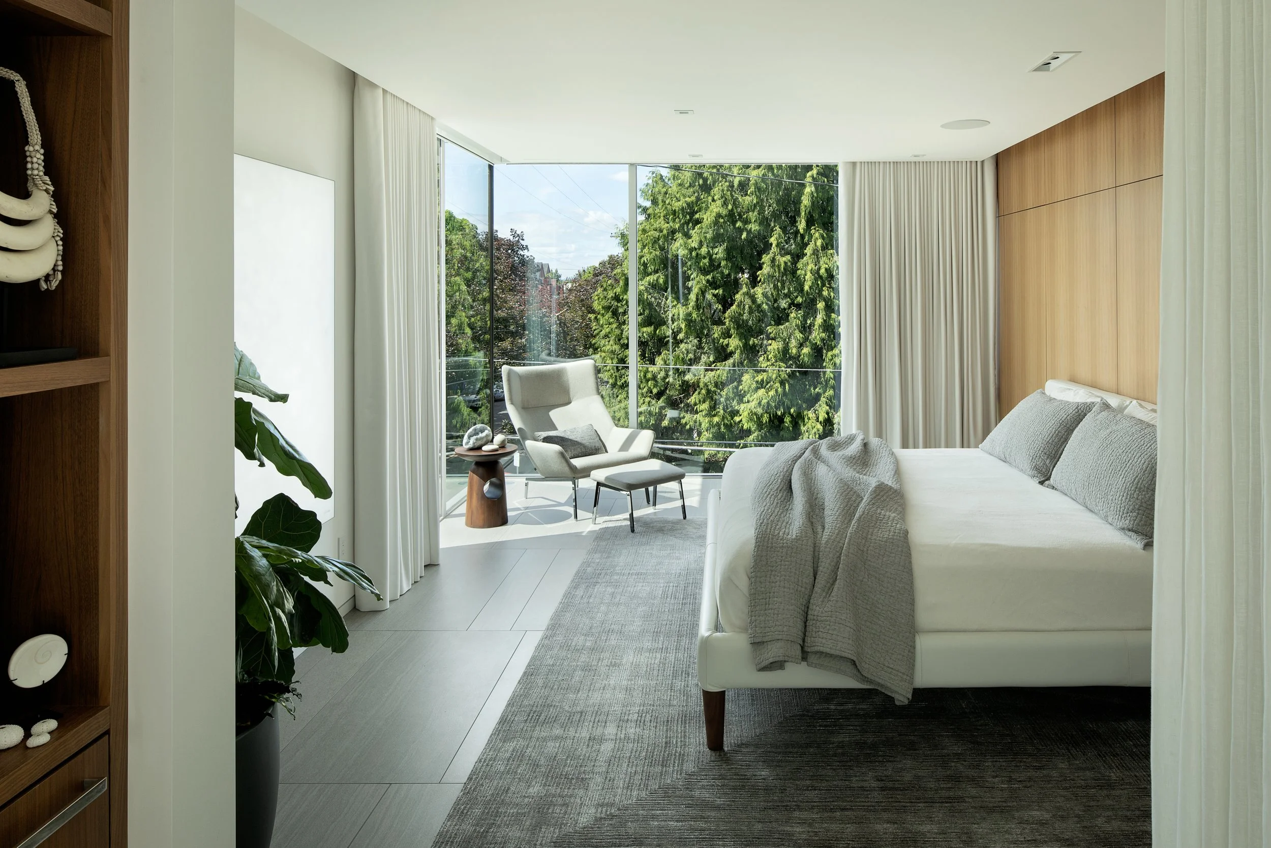 Modern bedroom with walnut walls and casework — William Kaven Architecture