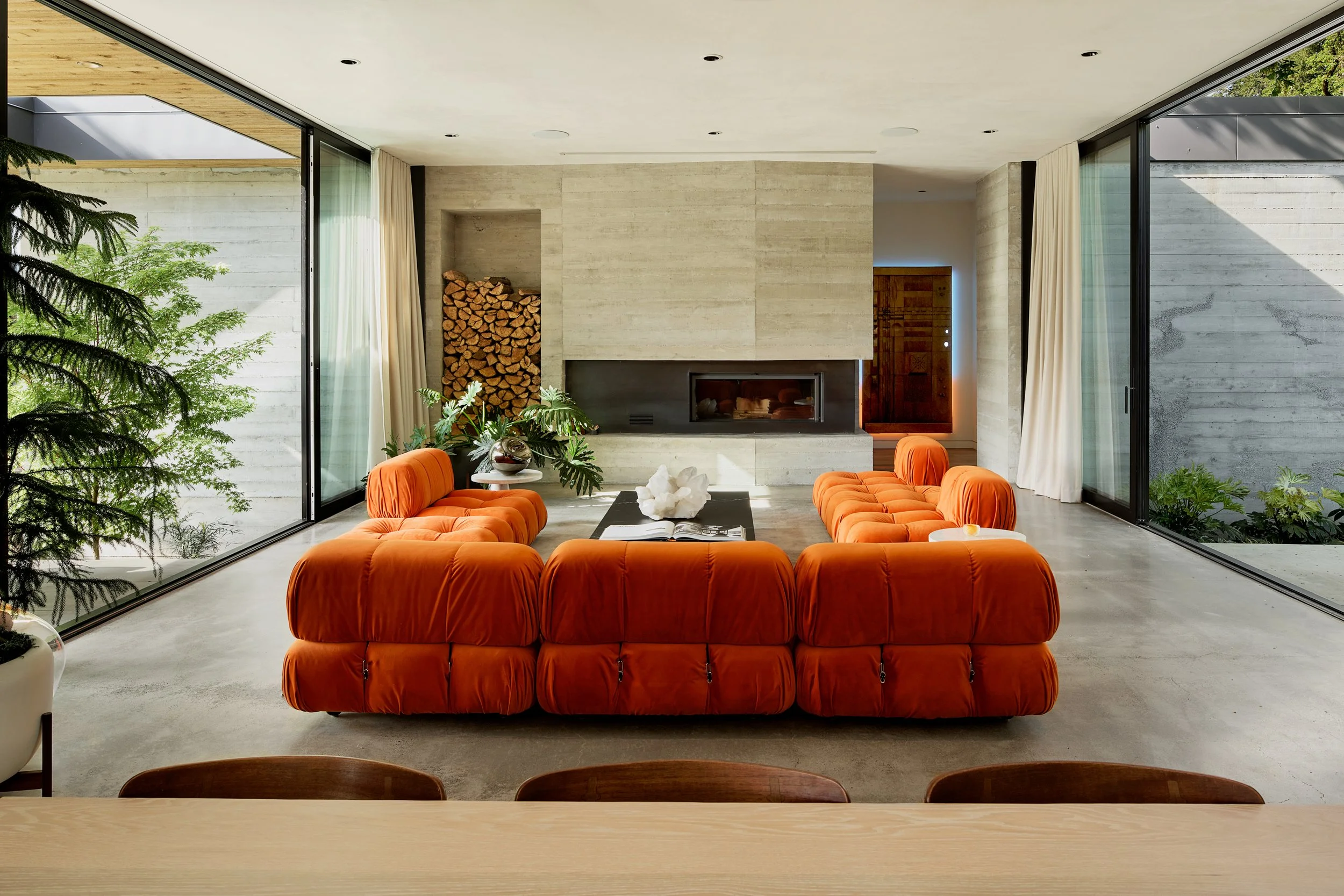 Modern living room with orange Mario Bellini Camaleonda sofa and fireplace — William Kaven Architecture