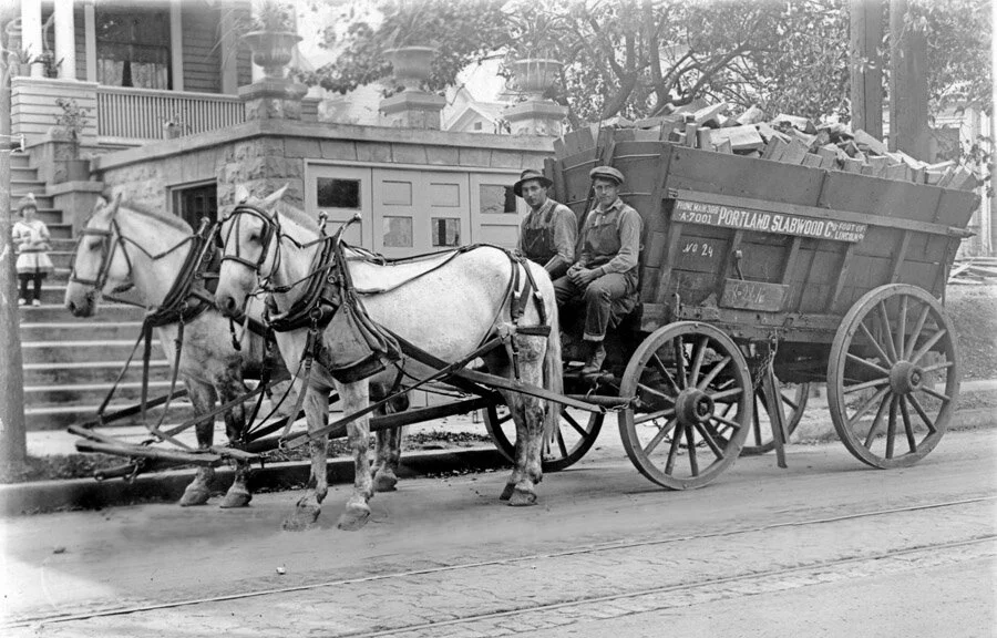 Historical photo of horses drawing a cart of lumber in Portland, Oregon — William Kaven Architecture