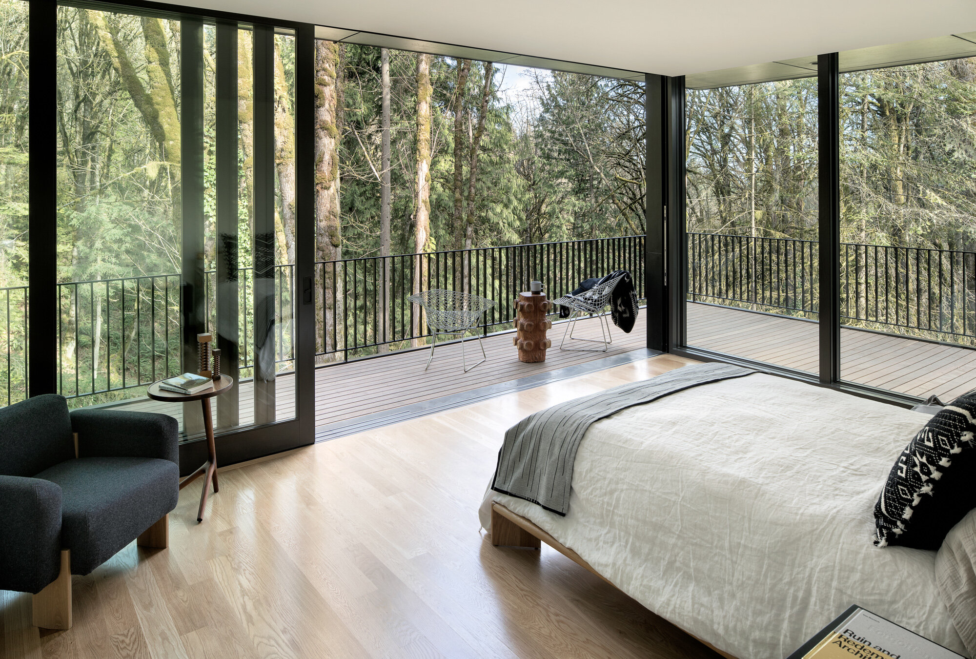 Modern bedroom with open window walls and terrace — William Kaven Architecture