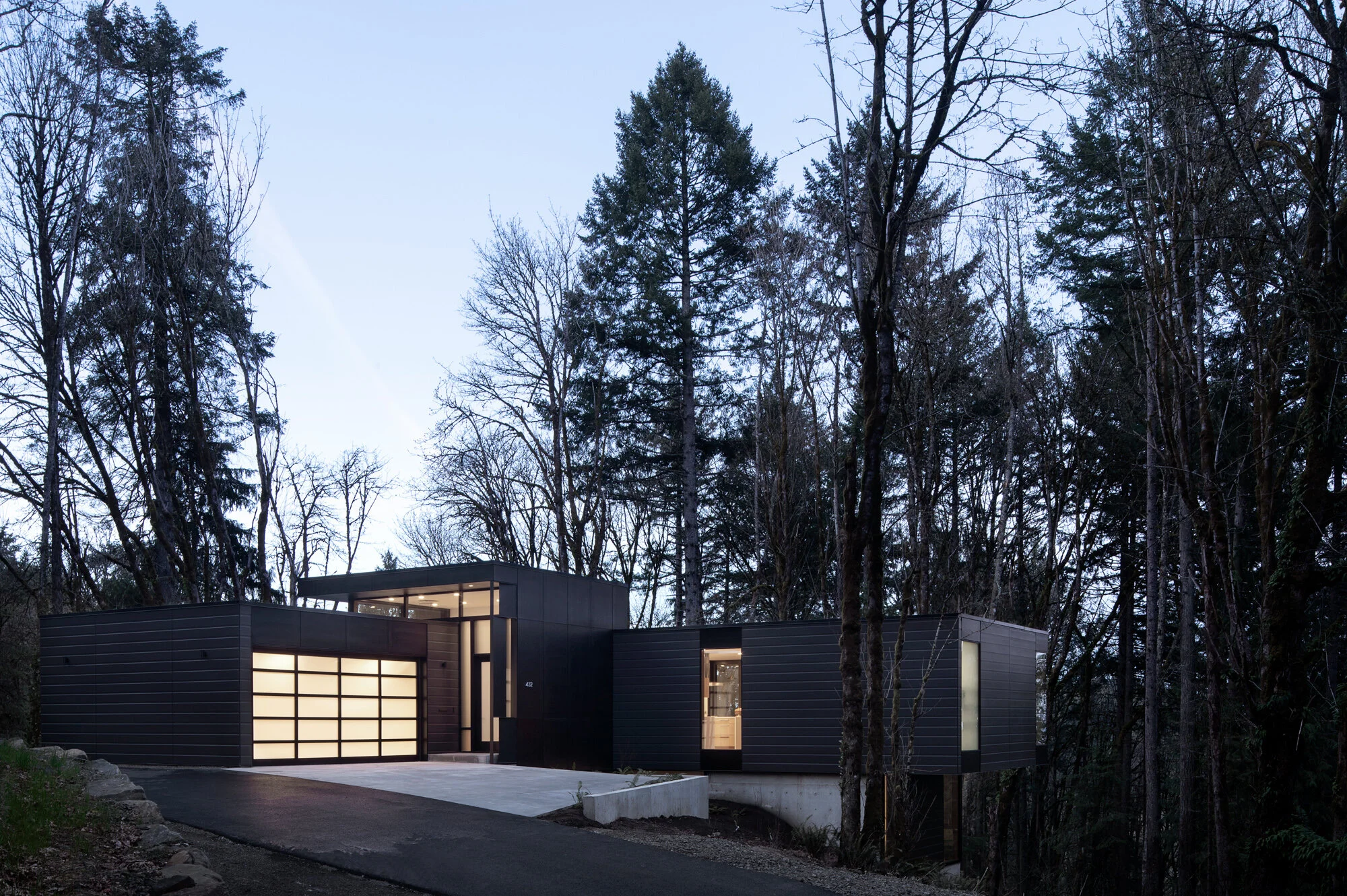 Black modern house at dusk — William Kaven Architecture