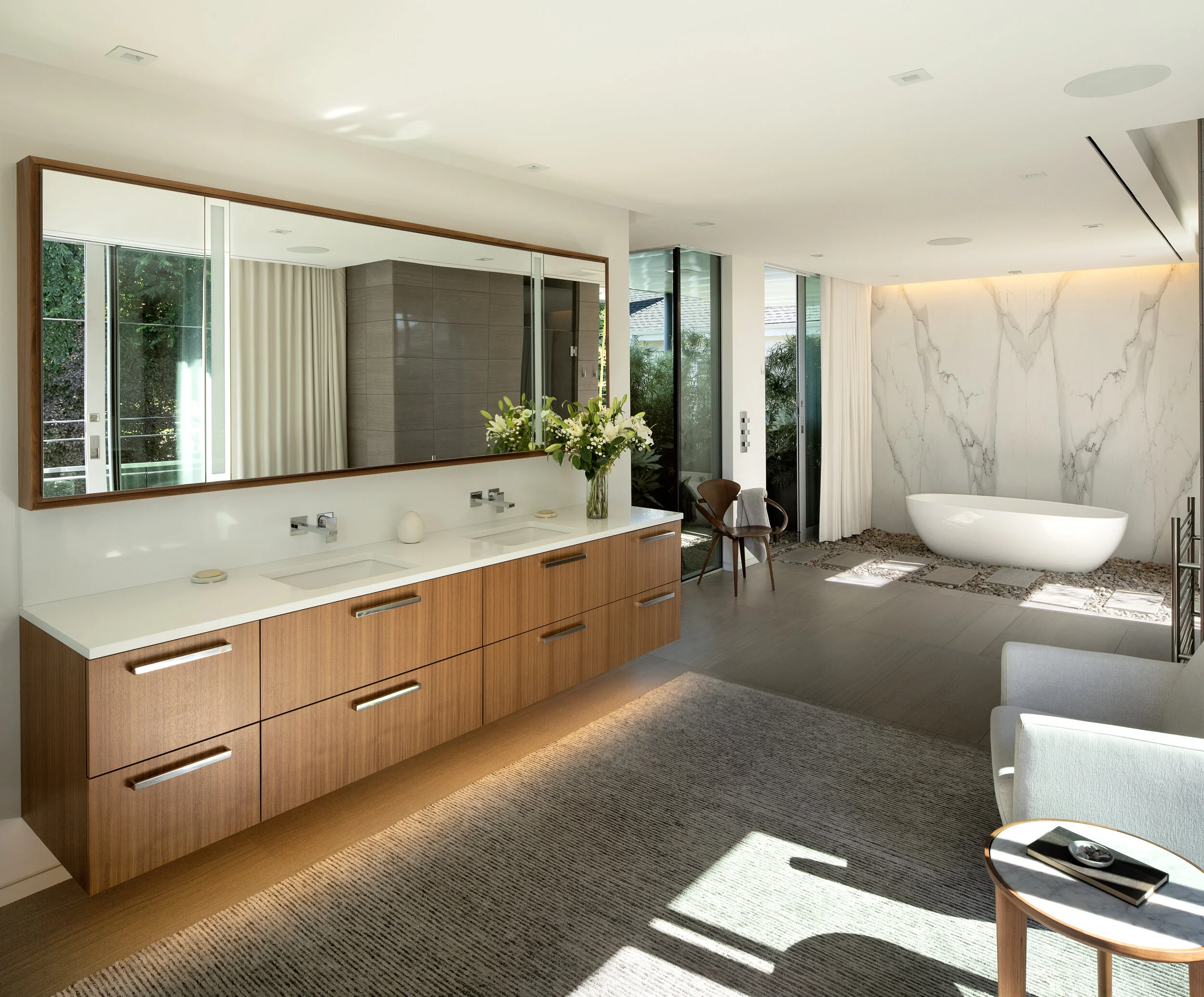 Primary bathroom with long vanity and soaking tub — William Kaven Architecture