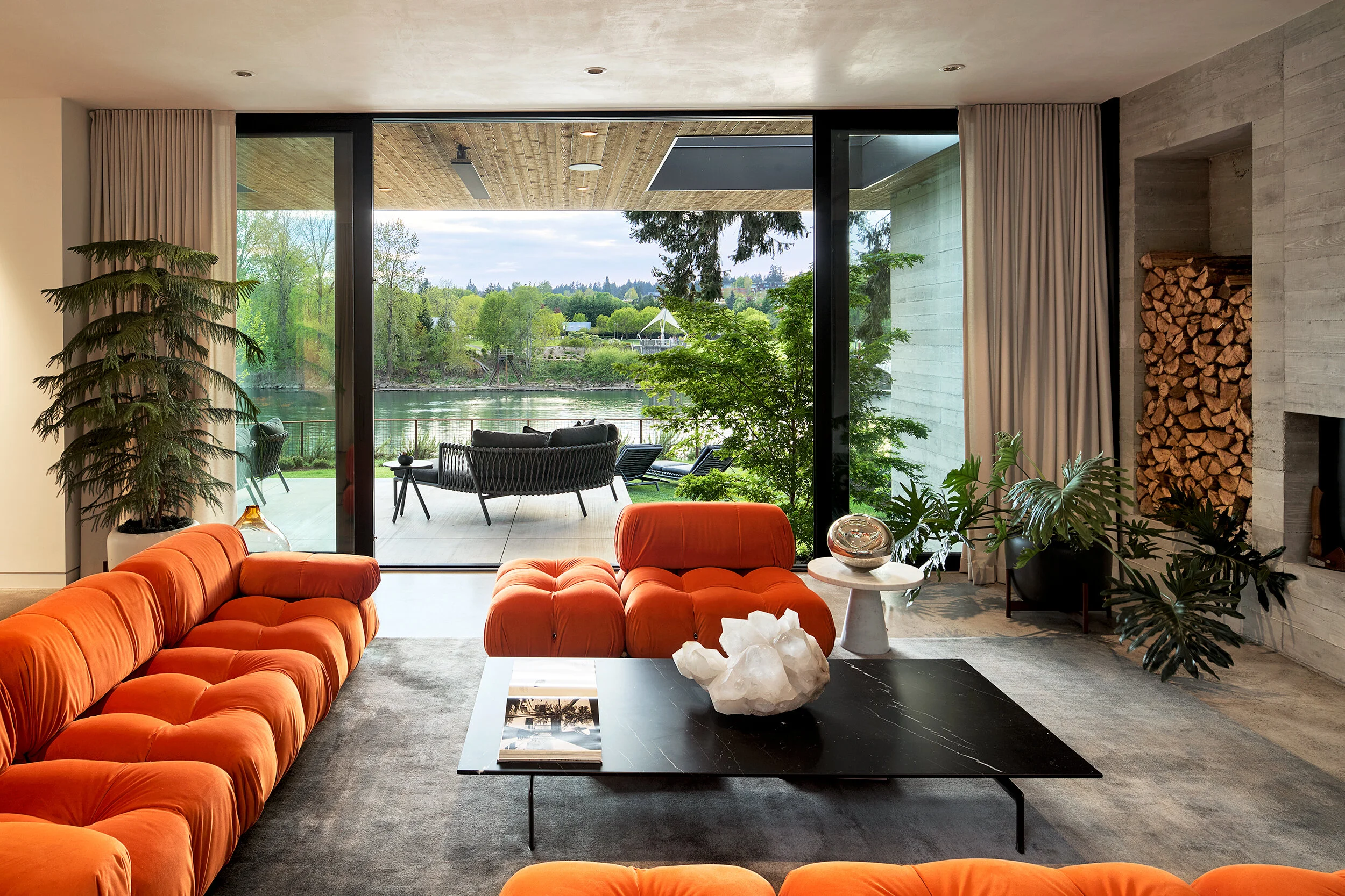 Modern living room with orange Mario Bellini Camaleonda sofa and view of river — William Kaven Architecture