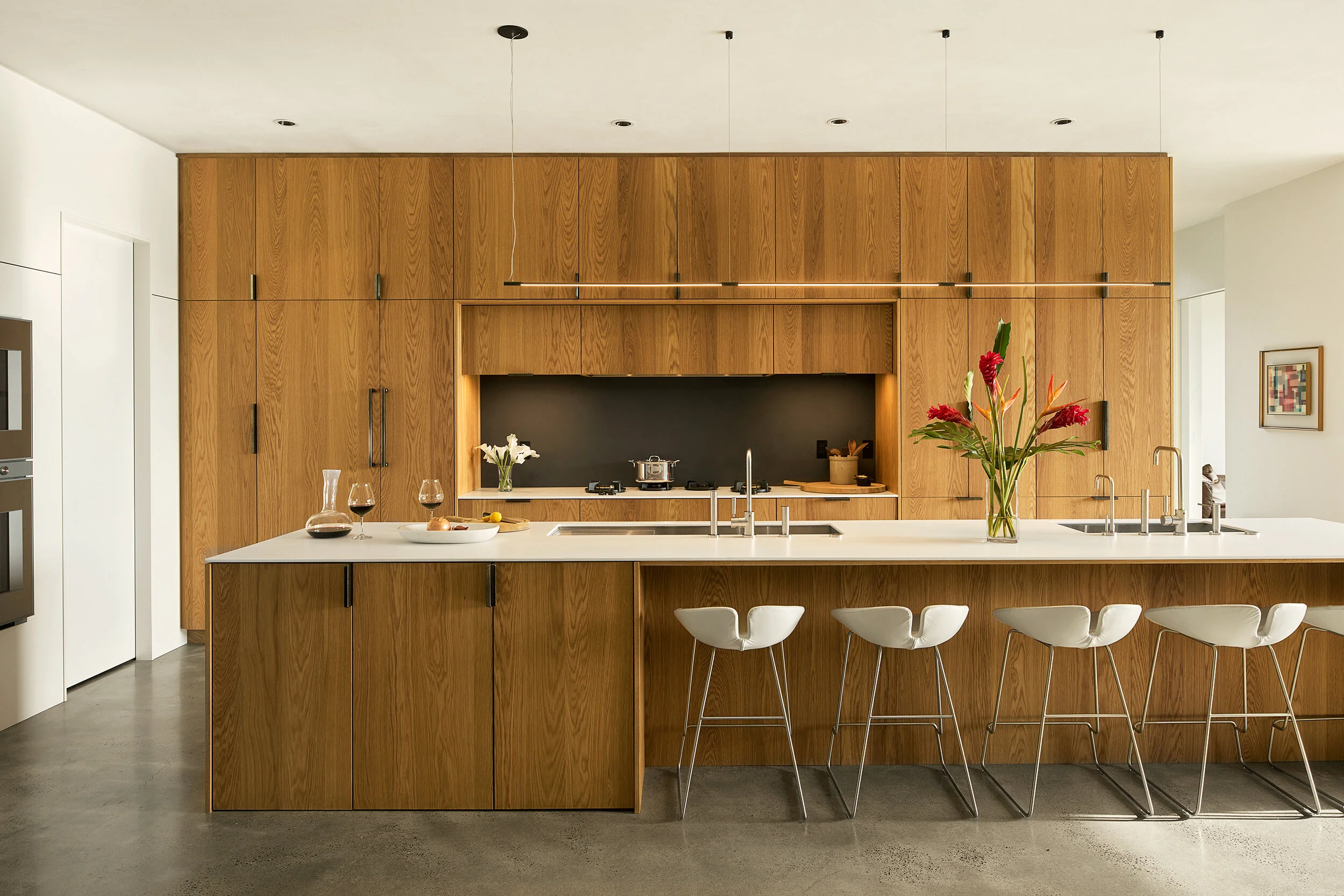 Kitchen with white oak cabinetry and seating area — William Kaven Architecture