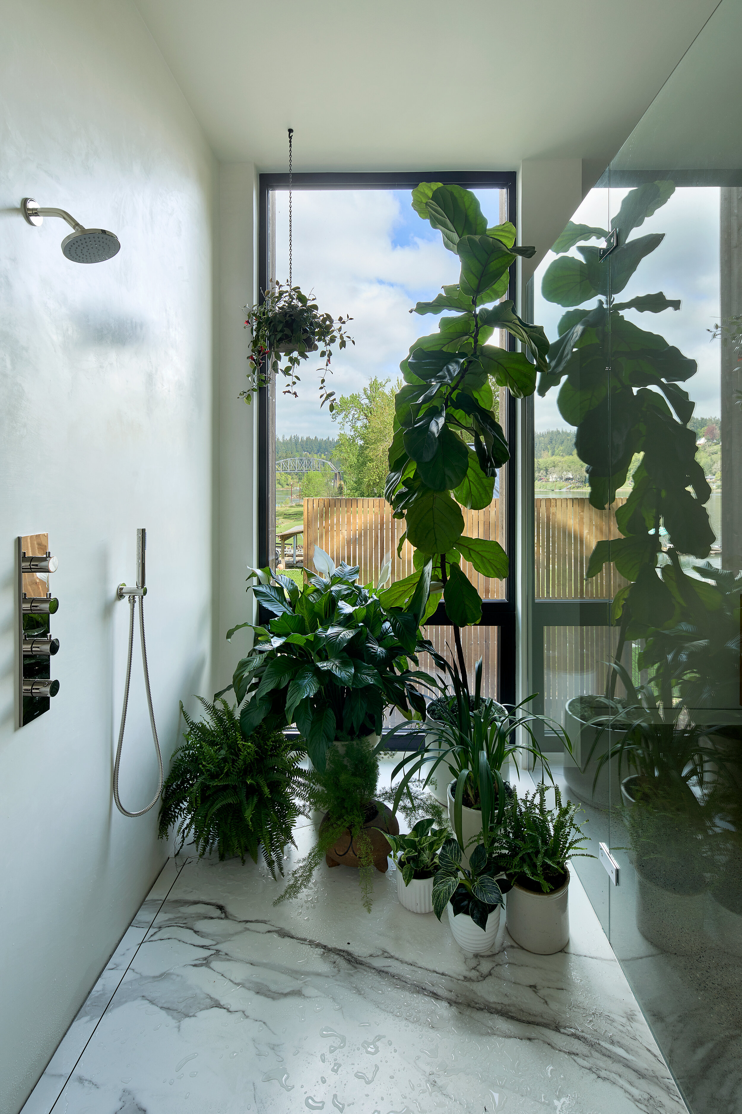 Shower with marble floor and plants — William Kaven Architecture