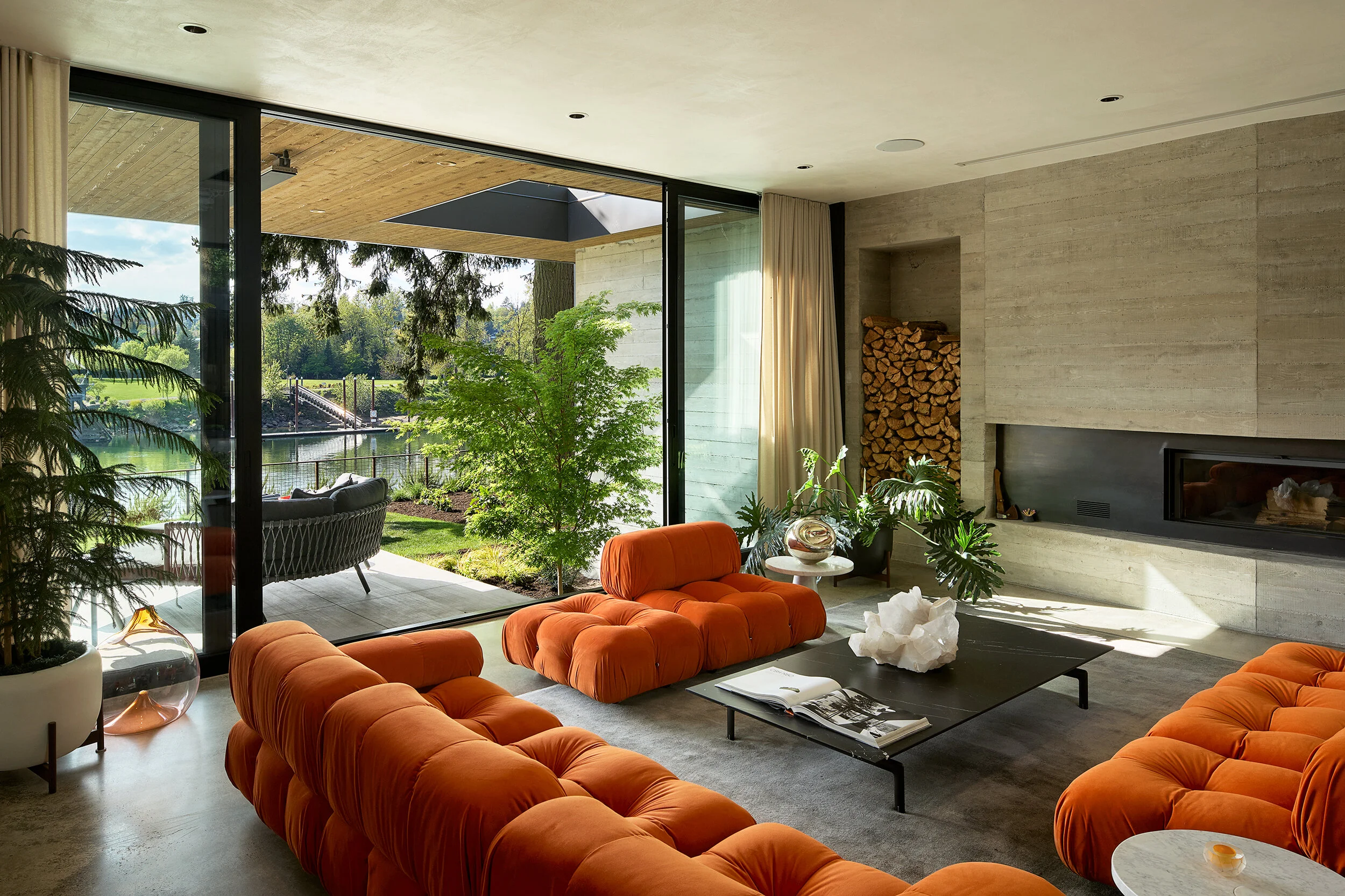 Living room with fireplace and orange sofa — William Kaven Architecture