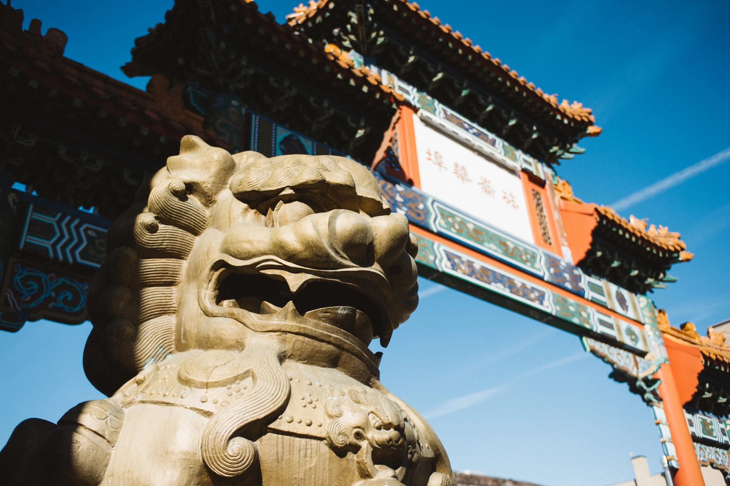 Portland Old Town Chinatown gate with closeup of foo dog statue head. Photo by Daniel Kaven of William Kaven Architecture