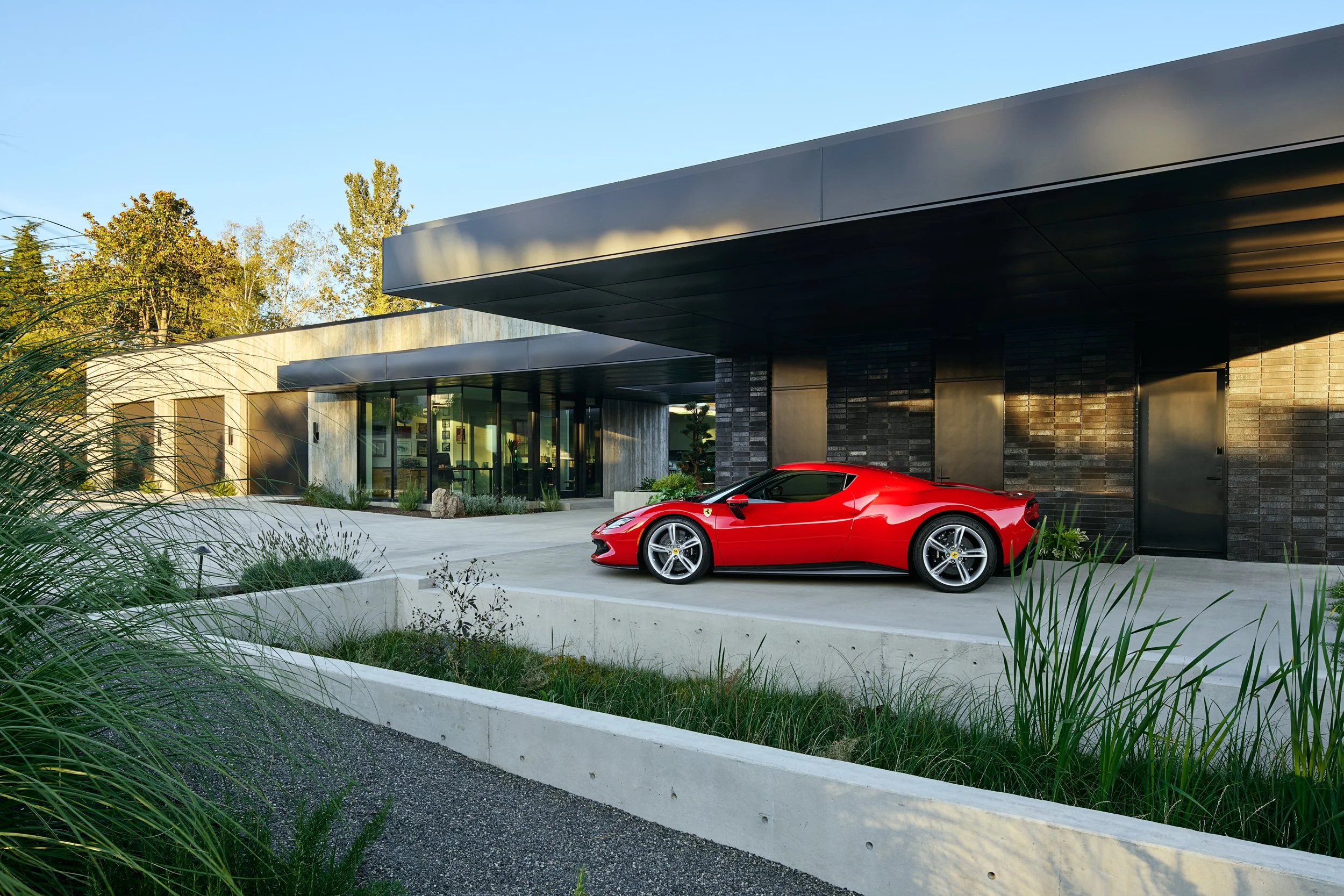 Red Ferrari under carport at El Capitola Residence, designed by William Kaven Architecture