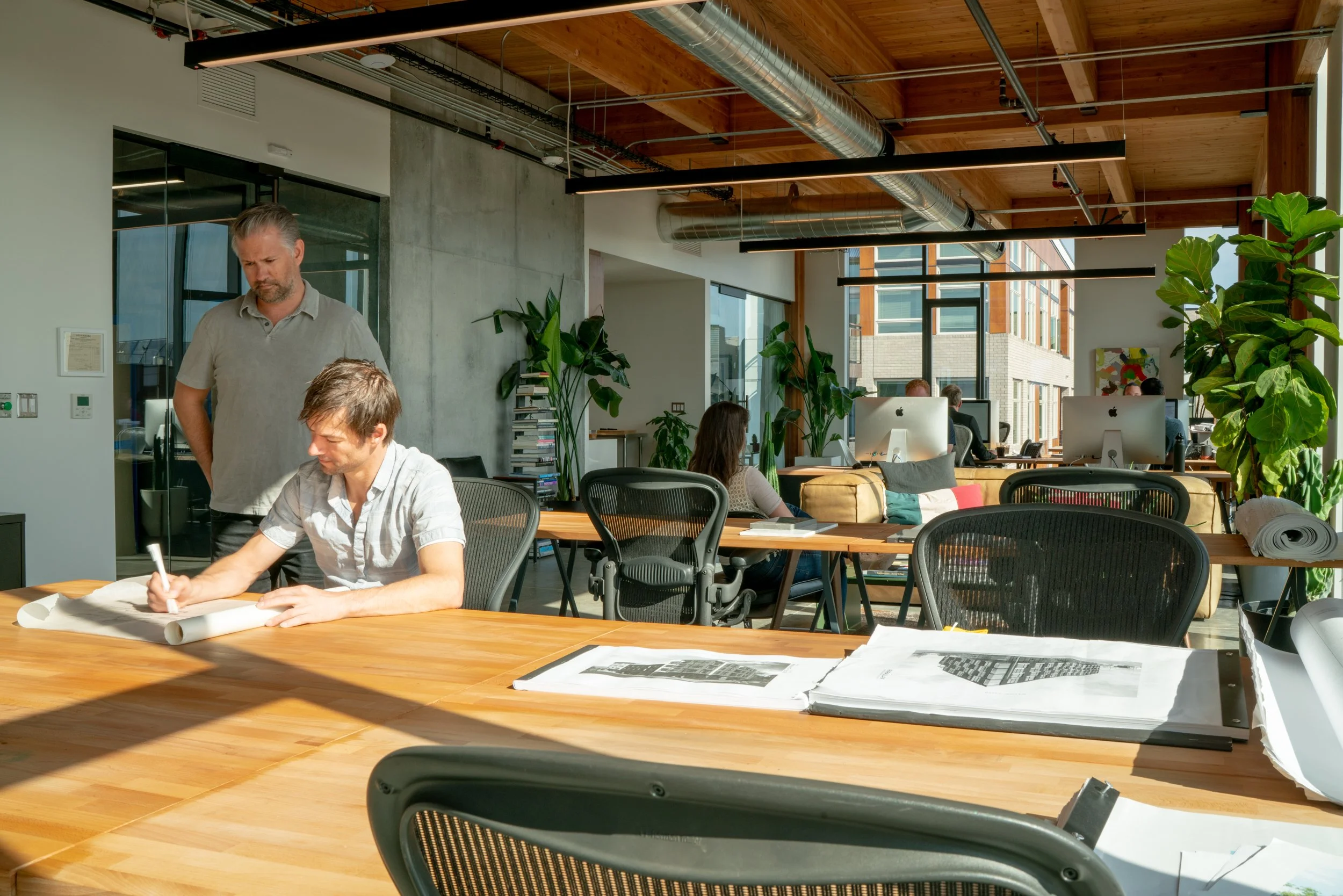 Architects drafting at William Kaven Architecture studio in Silica building, Portland, Oregon.