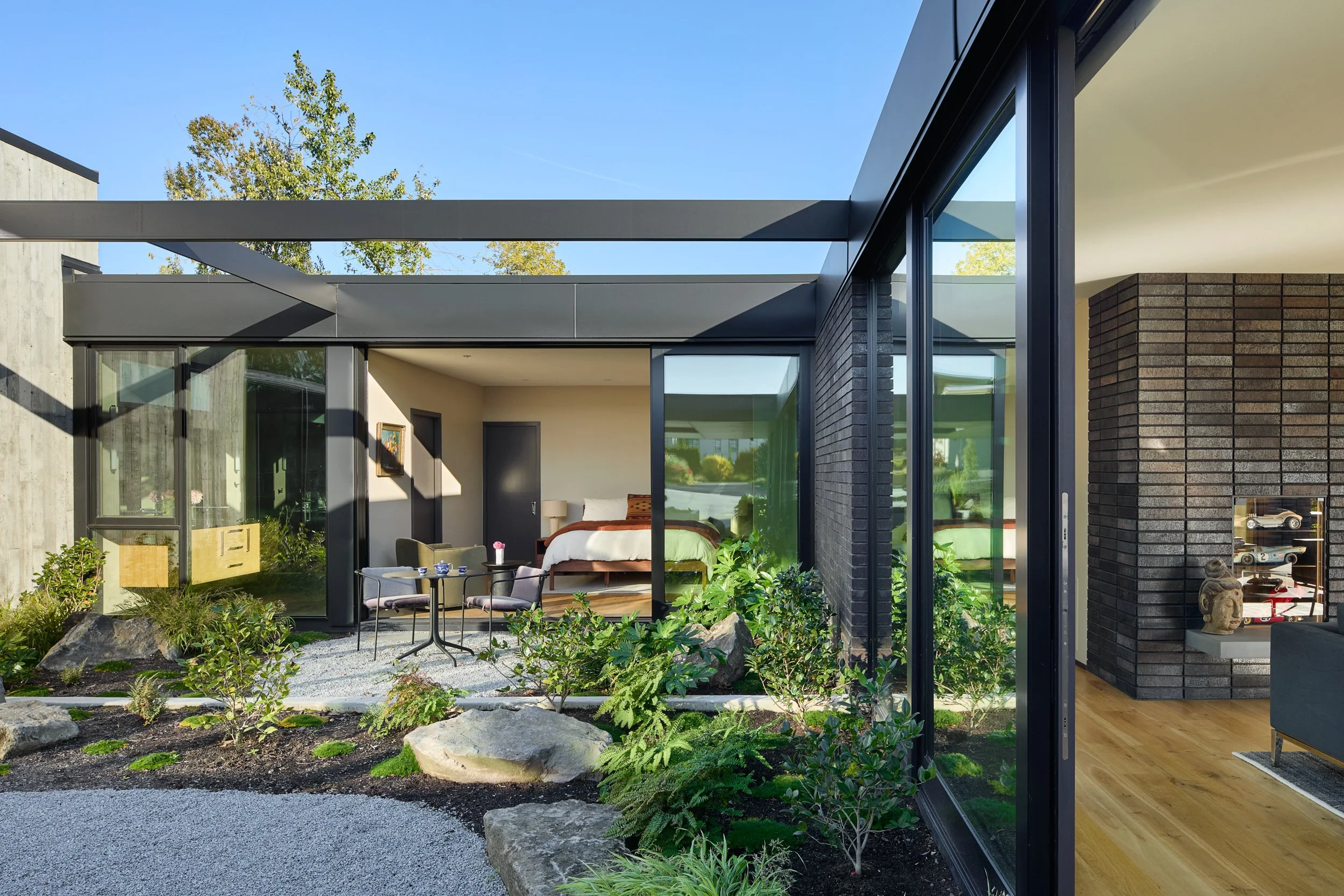 Residential courtyard with view of guest room and living room — William Kaven Architecture.