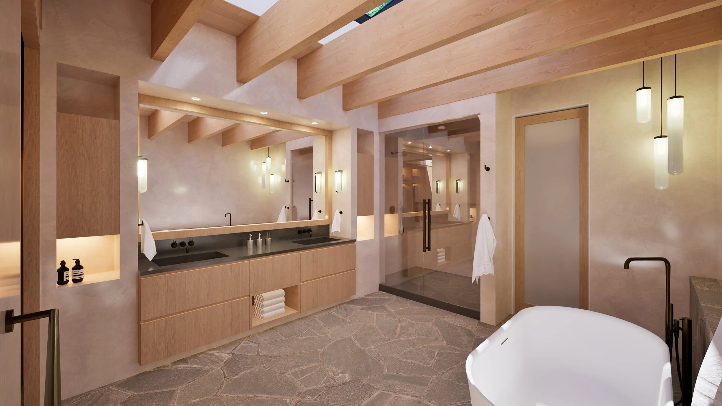 Primary bathroom with soaking tub and stone floor — William Kaven Architecture.