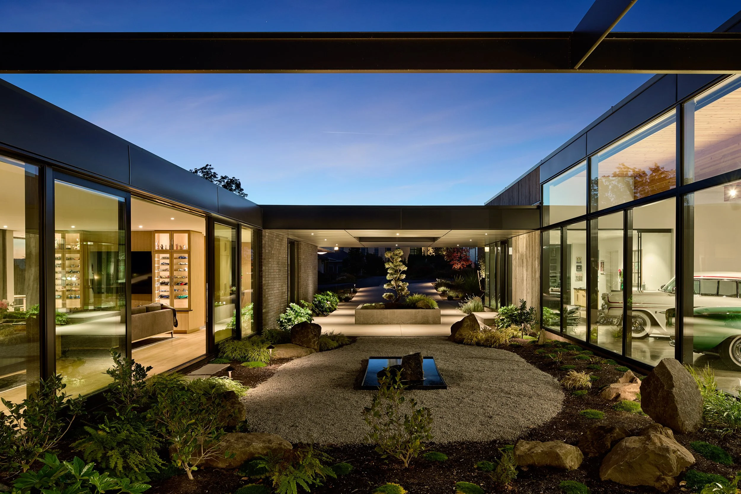 View of residential courtyard with reflecting pool and juniper tree — William Kaven Architecture.