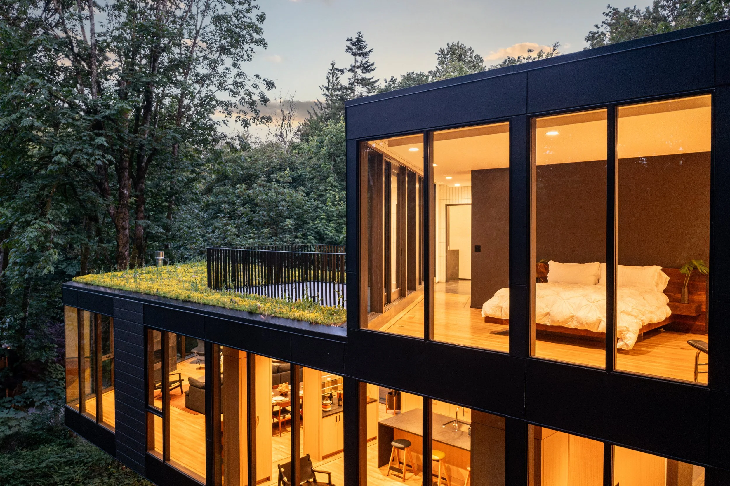 Modern house with green roof at dusk — William Kaven Architecture