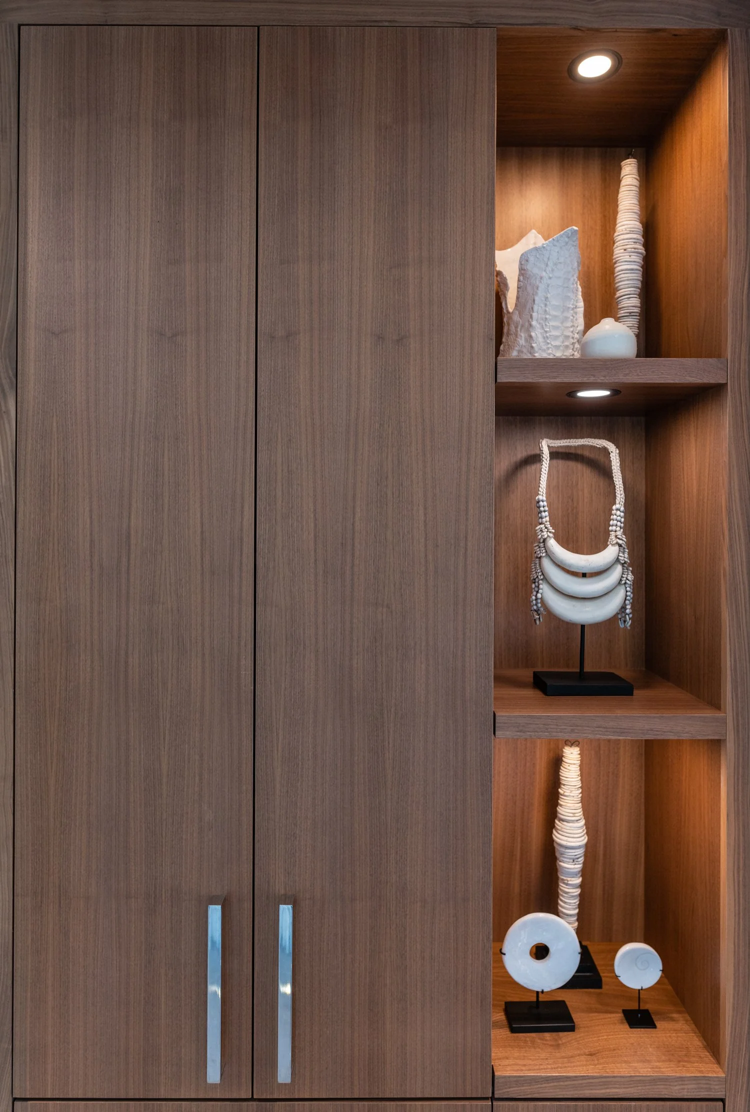 Walnut casework displaying artifacts and jewelry — William Kaven Architecture