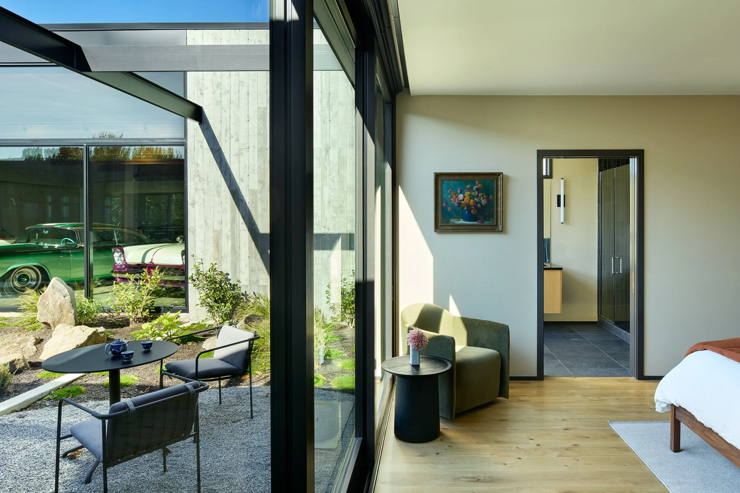 Room with floor-to-ceiling windows and view of courtyard — William Kaven Architecture.