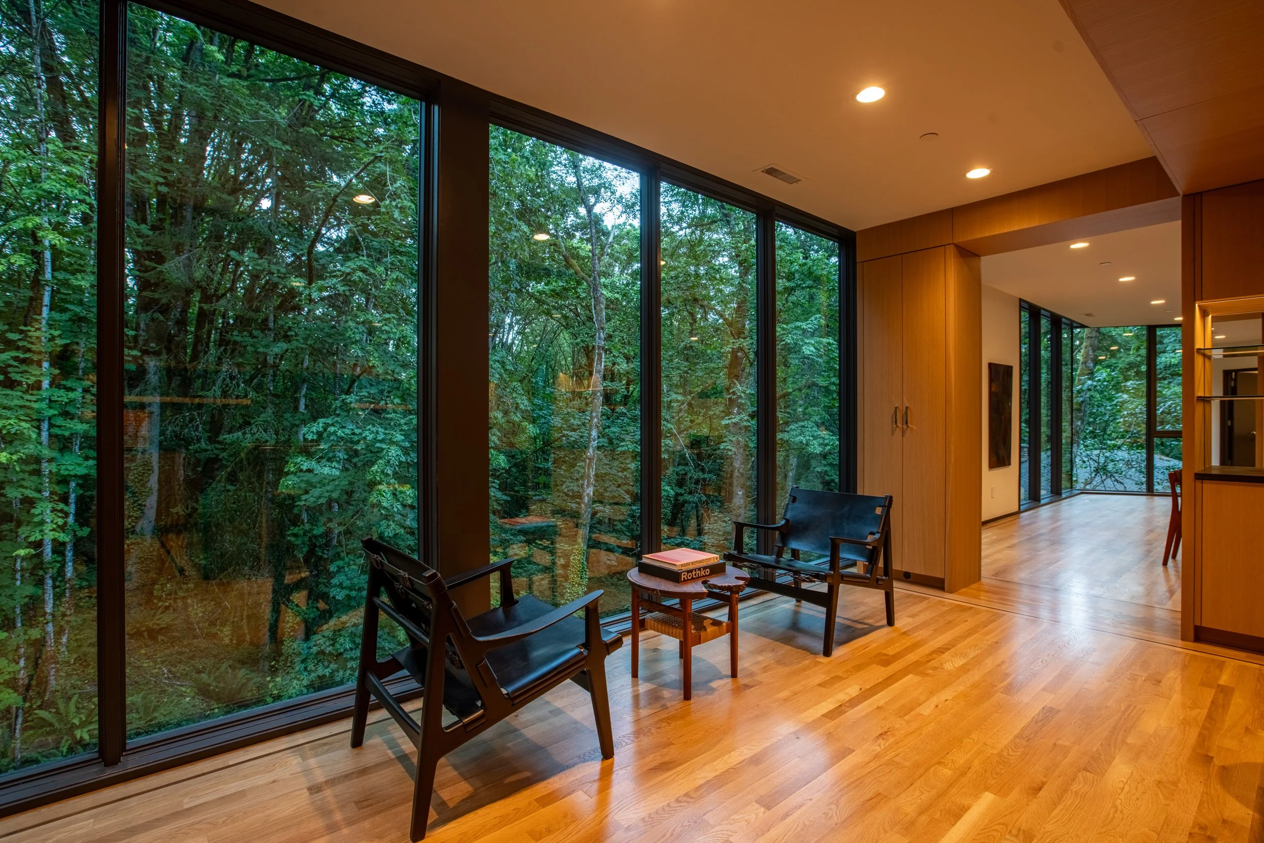 Kitchen seating area with view of forest — William Kaven Architecture