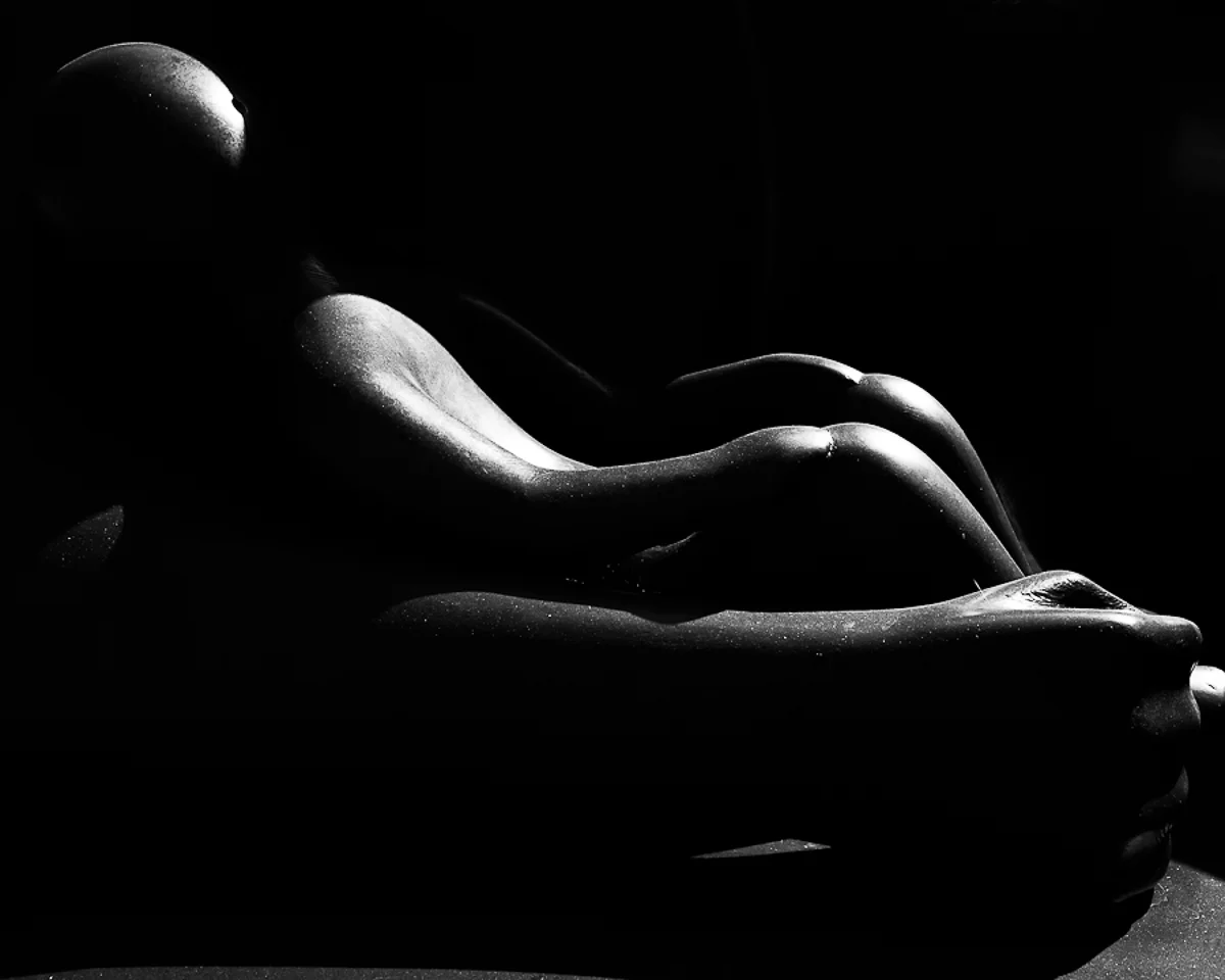 Monochrome Solitude: Abstract Vision of a Man in Repose  in Shadows and Form